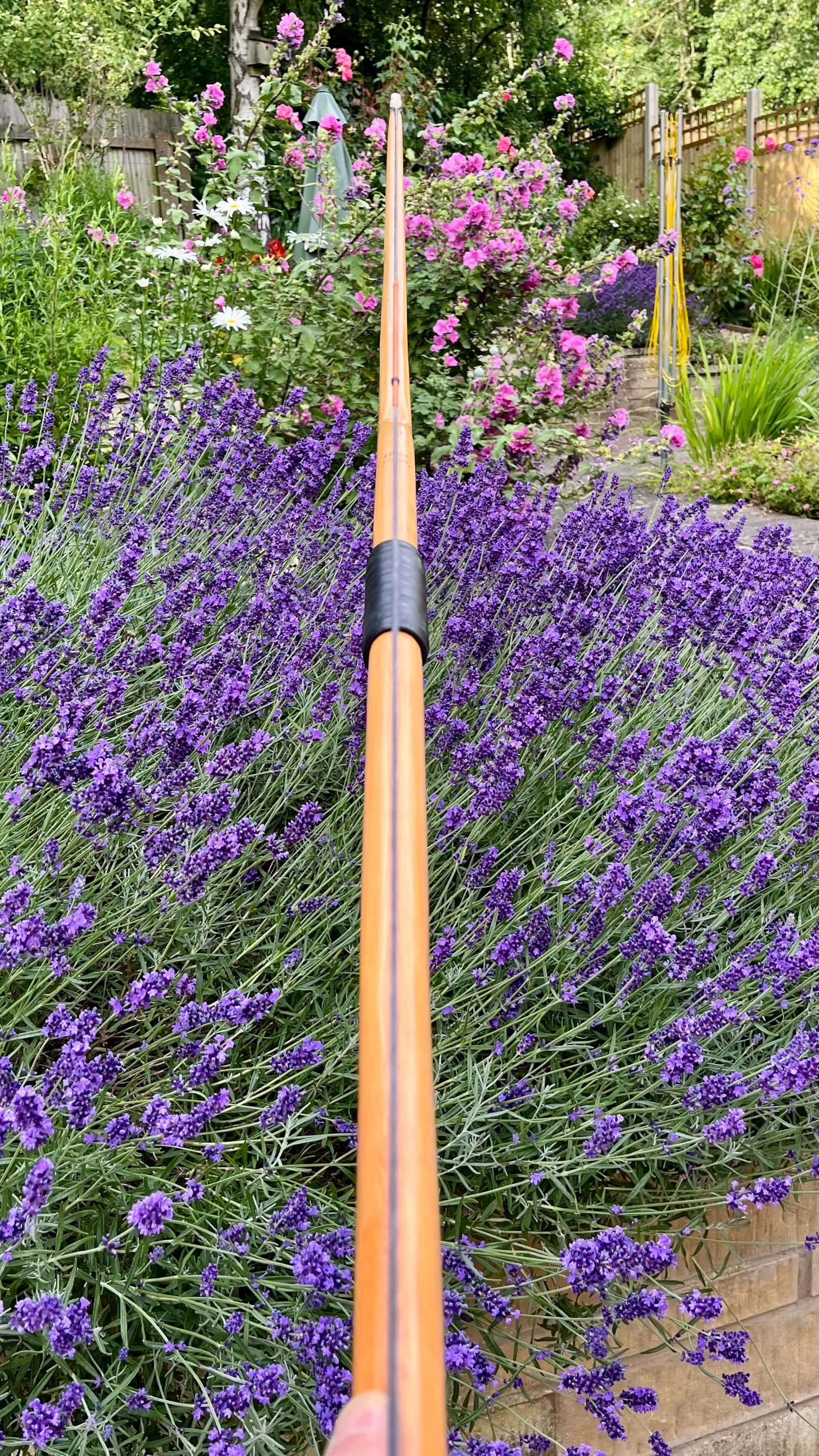 A strung English longbow showing that the string bisects the handle section precisely.