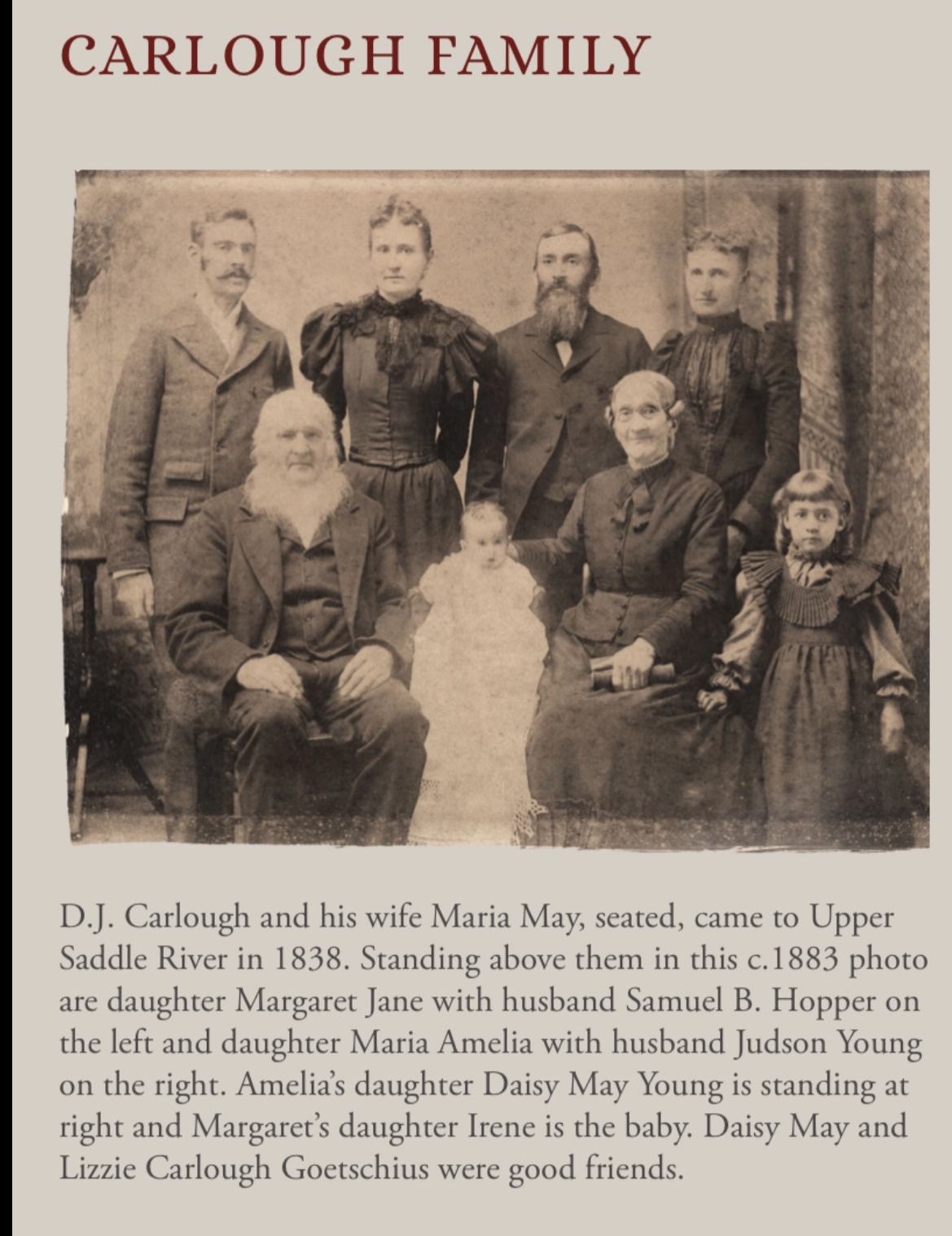 A sepia-toned family portrait featuring nine people, with a seated elderly man and woman, two young girls, and other adults standing behind them, taken circa 1883.