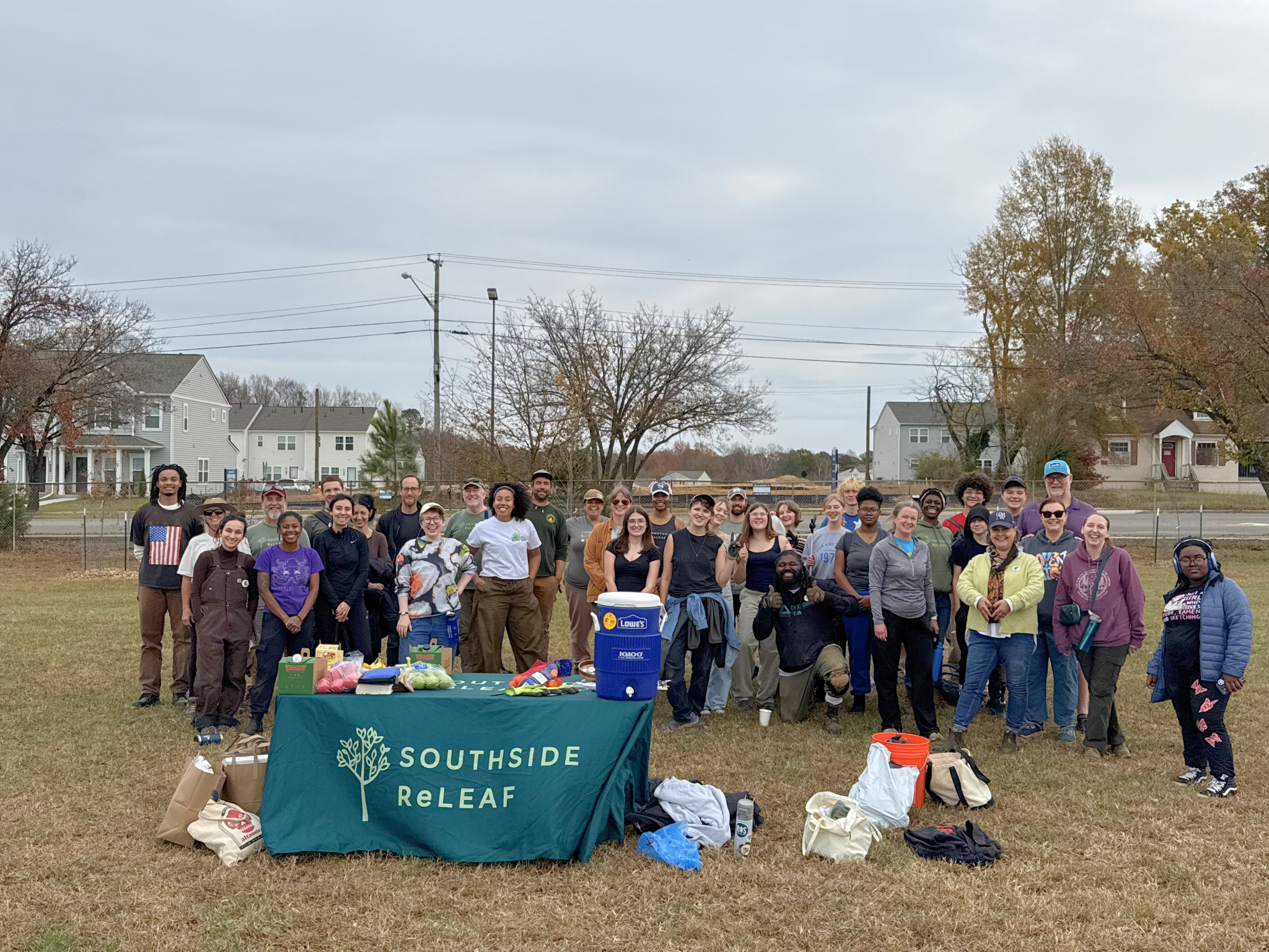 Volunteers pose for a group photo at the end of the tree planting workday at Boushall Middle School on November 15, 2025.