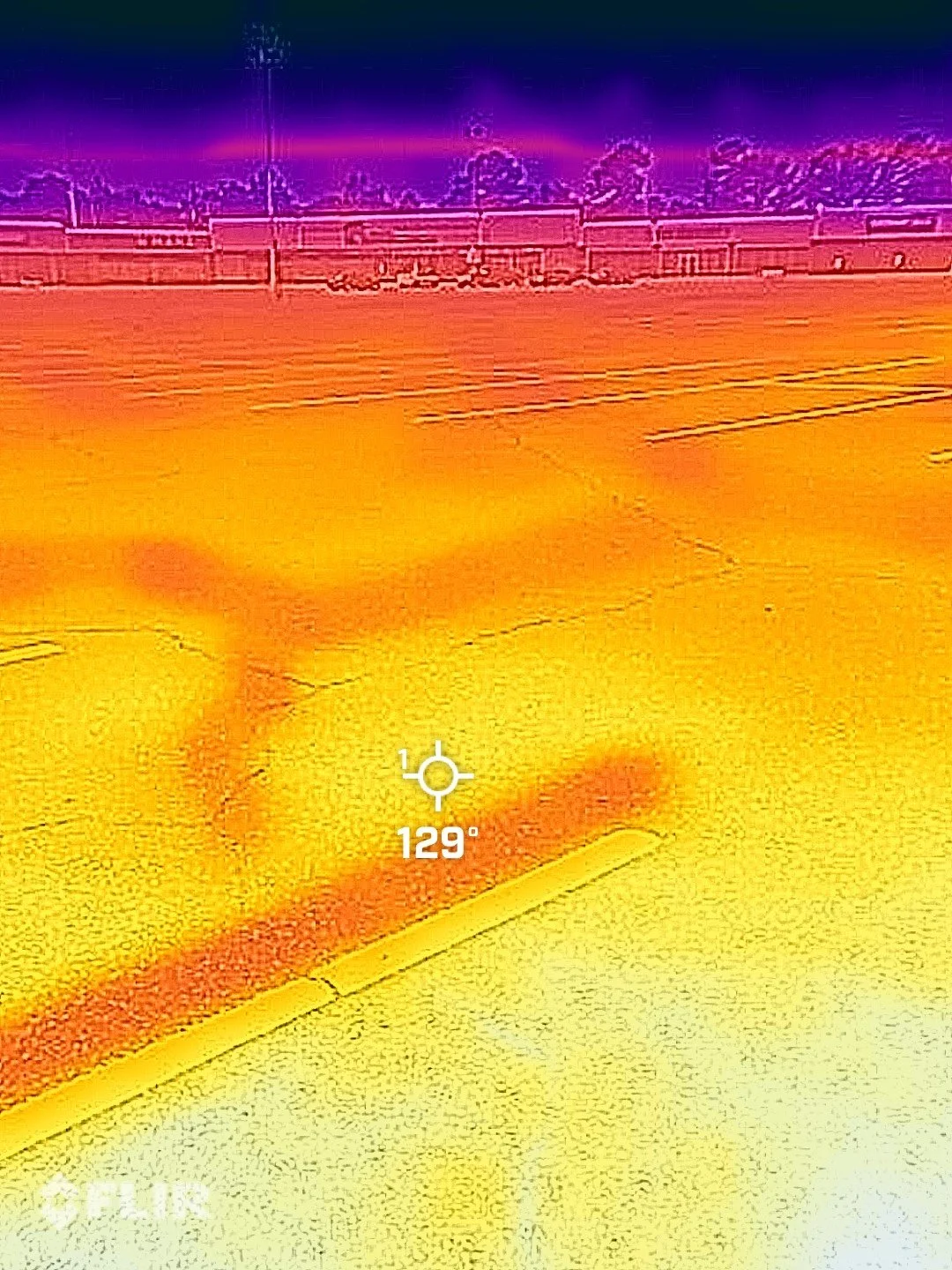 A thermal image from Southside Plaza shows a temperature of 129 degrees in the unshaded parking lot. The purple color over the trees in the distance shows cooler temperatures in the shade.
