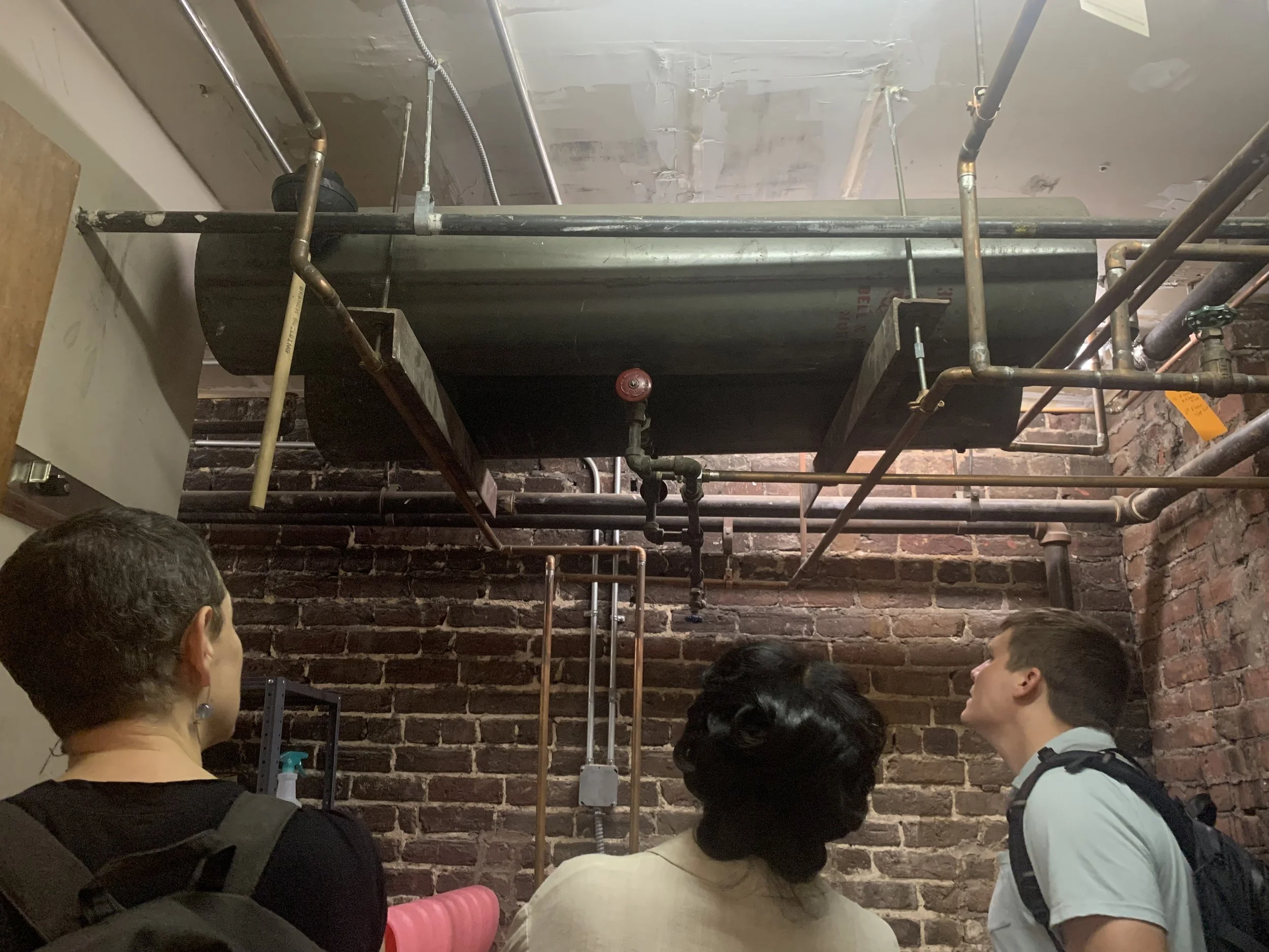 Jacqui Bauer (left) and Coles Jennings (far right) from C3’s Business Partnerships Team complete an energy audit at the Well Collective in Richmond, VA.
