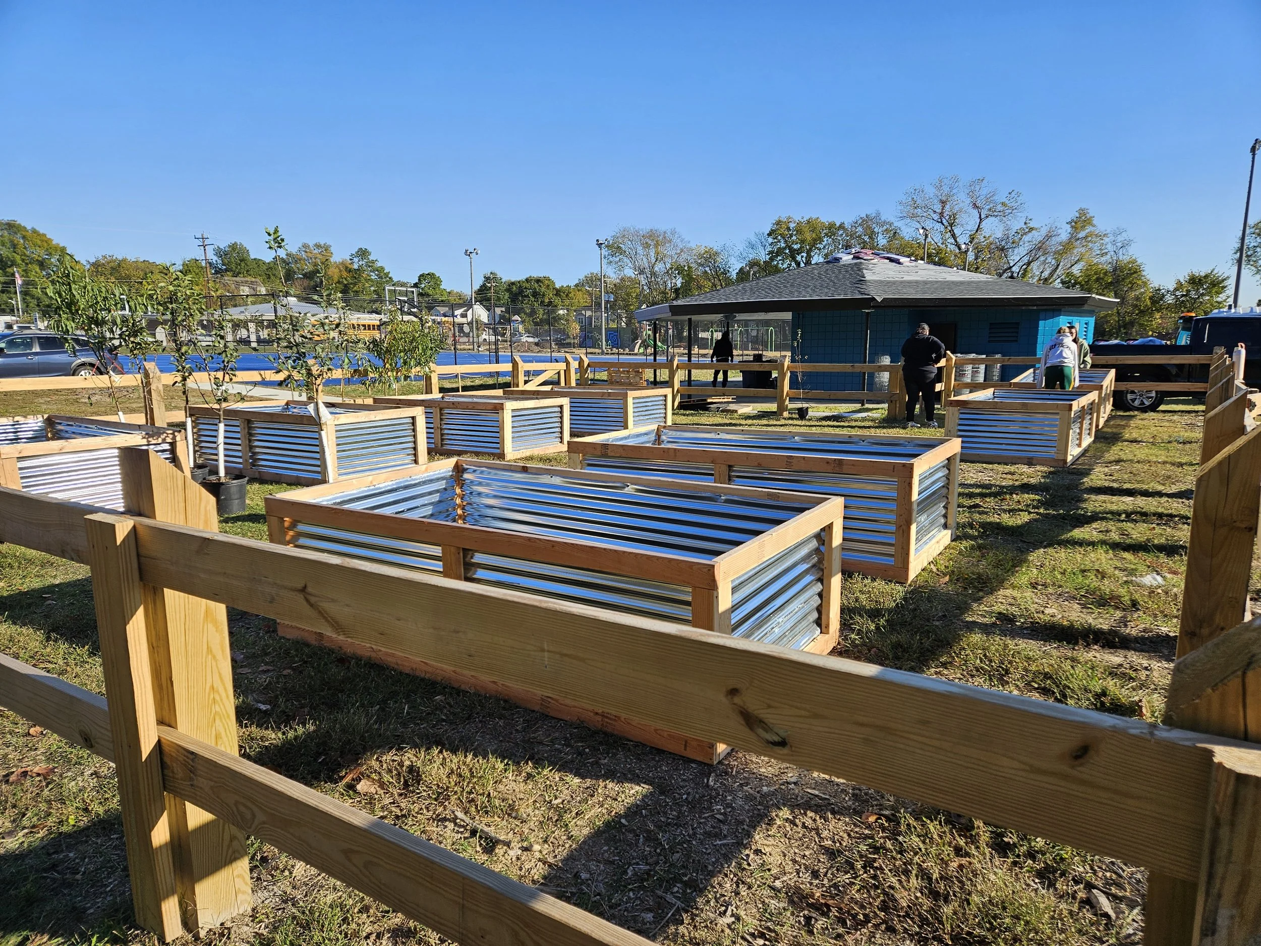 Volunteers move raised garden beds into the new Blackwell Community Garden.