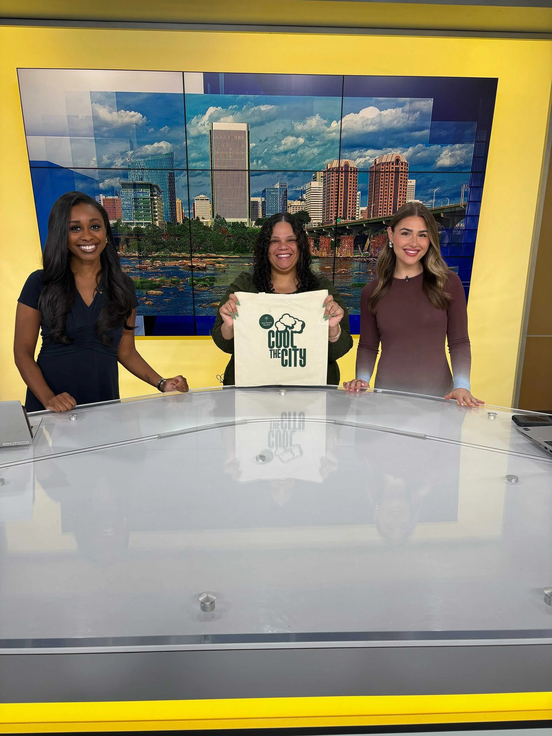 Co-founder Amy Wentz reps a Cool the City tote bag in a photo with Autumn Childress and Madison Moore at the end of a live TV interview for ABC 8.