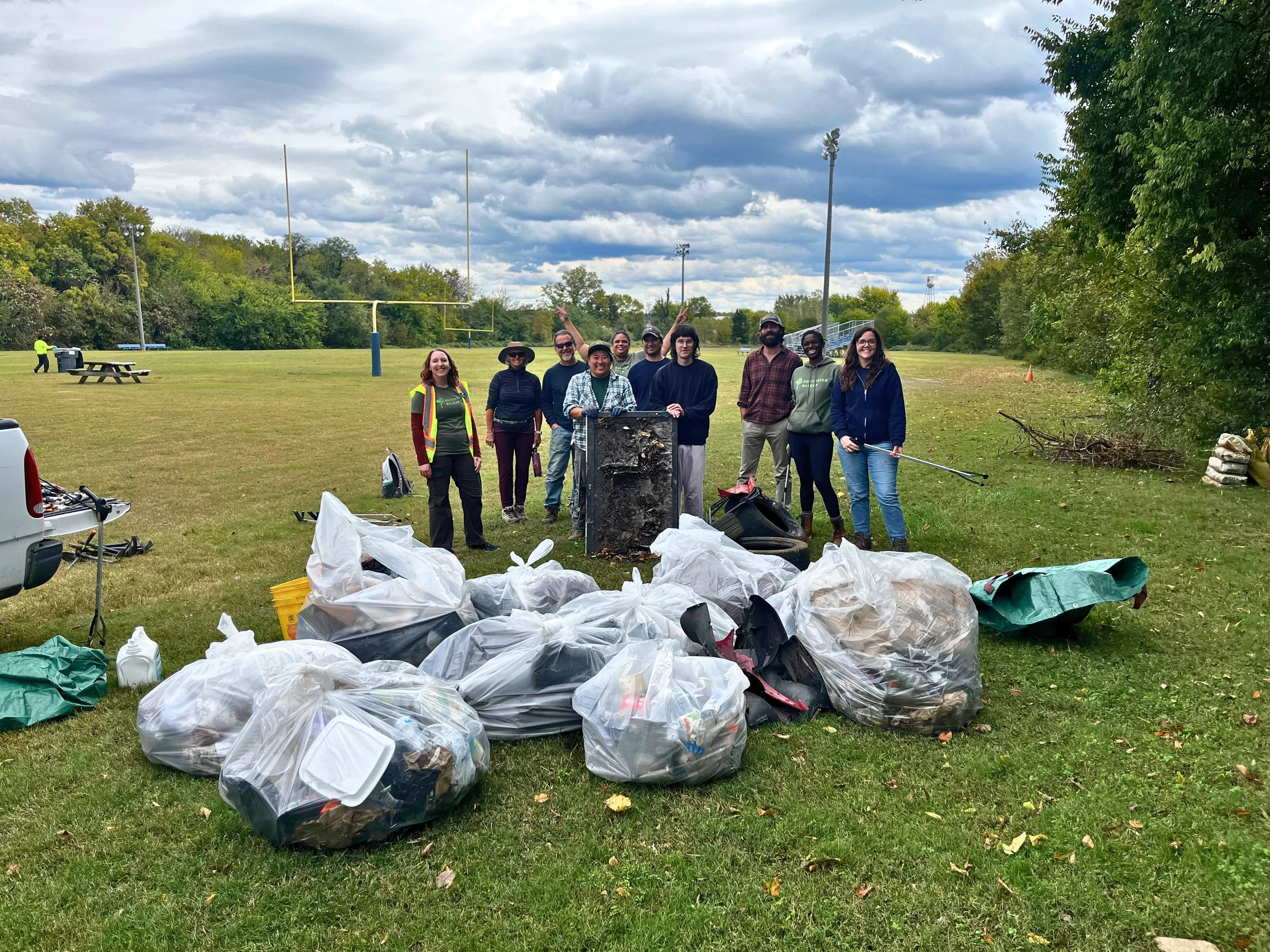 Volunteers posing with all the trash they cleaned out of Blackwell Park during a Richmond Tree Week workday.