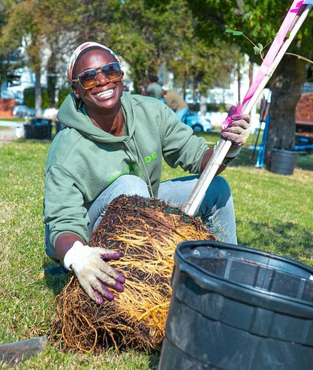 Lisa planting a tree at Southside ReLeaf’s Blackwell Elementary School tree planting during Richmond Tree Week 2024.
