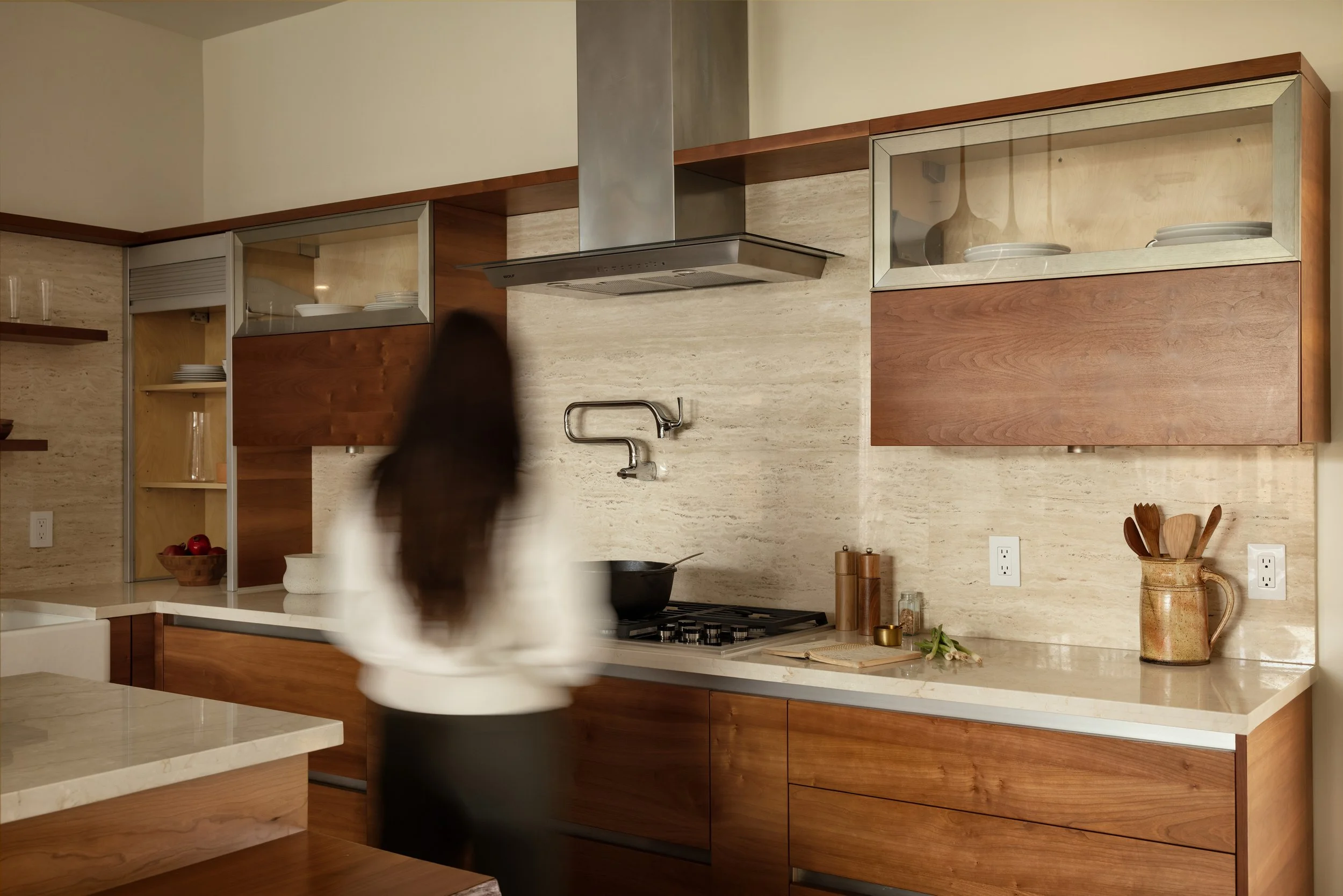 Woman cooking in kitchen, in Frisco Texas, in the Tapestry Community by Total Environment