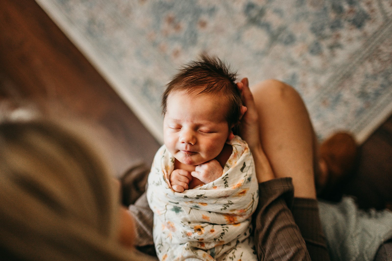 closeup-newborn-swaddled-flowers.jpg