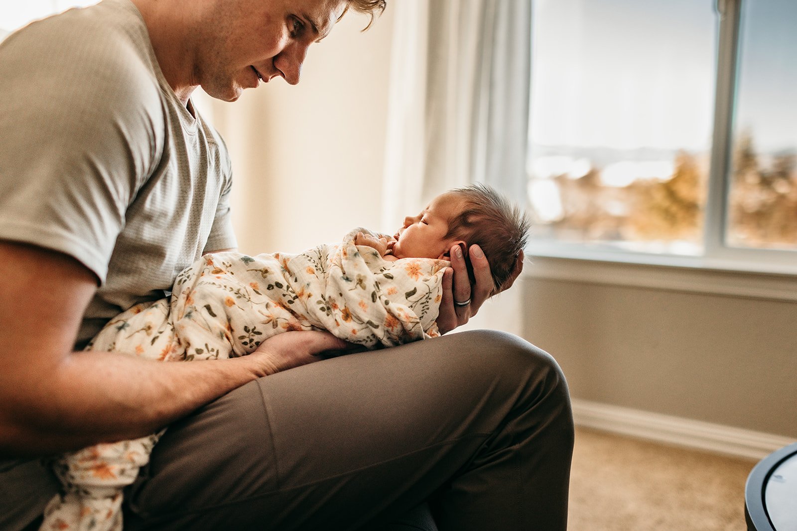 father-holding-newborn-with-gentle-care.jpg