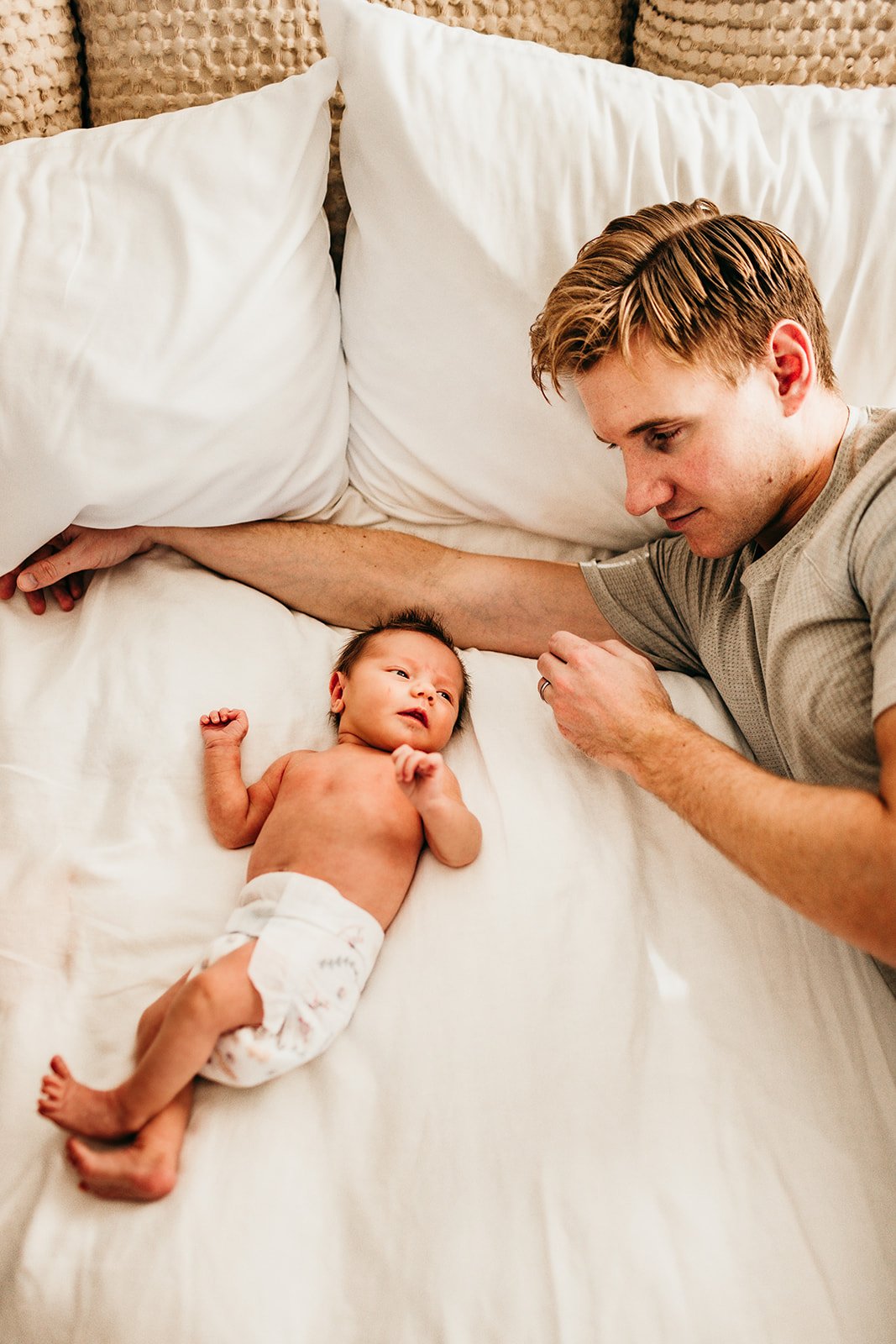 father-playing-with-baby-on-bed.jpg