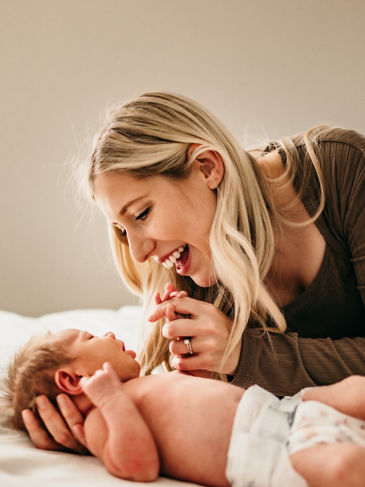 mother-cradling-newborn-bedroom.jpg