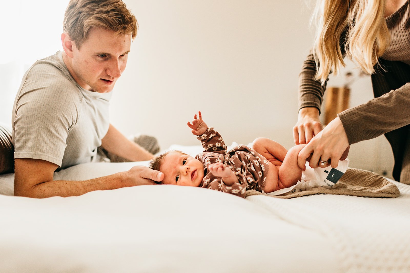 newborn-baby-playtime-with-parents-bed.jpg