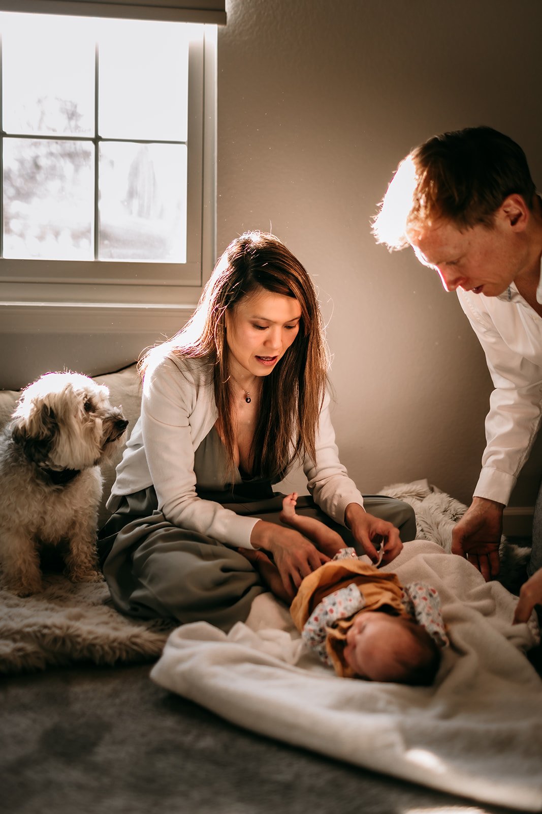 new-parents-taking-care-of-newborn-with-dog.jpg