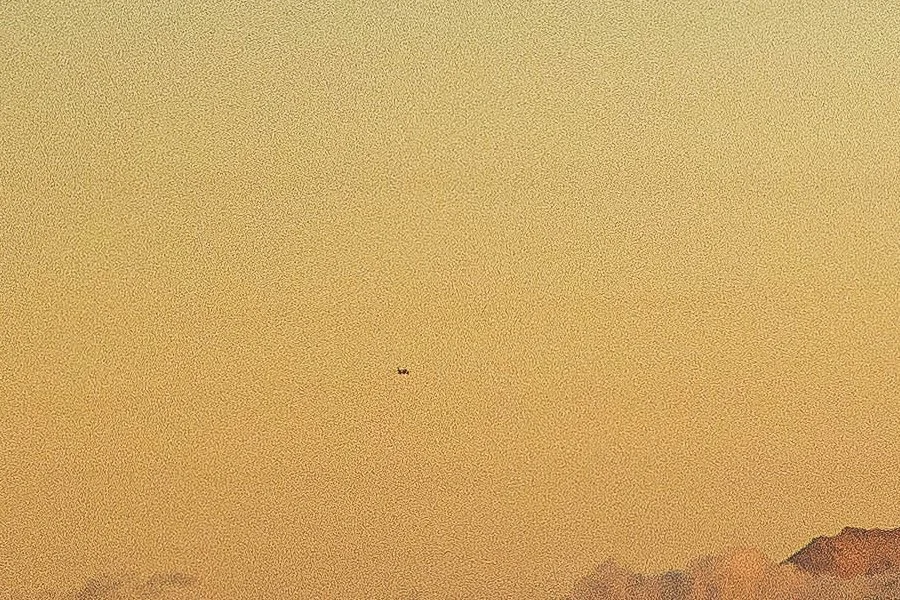 Close detail of an F-15 crossing the amber sky beside Mount Hood