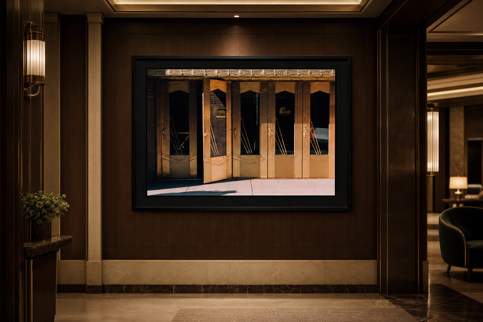 Open Door Policy displayed in a wide black frame inside a dark luxury hotel corridor
