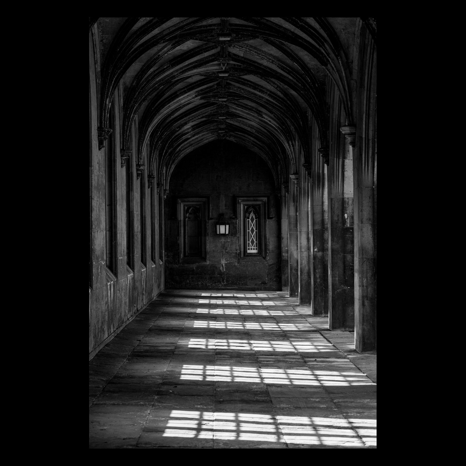 A Measure of Light & Dark black-and-white corridor photograph presented in full against a dark background