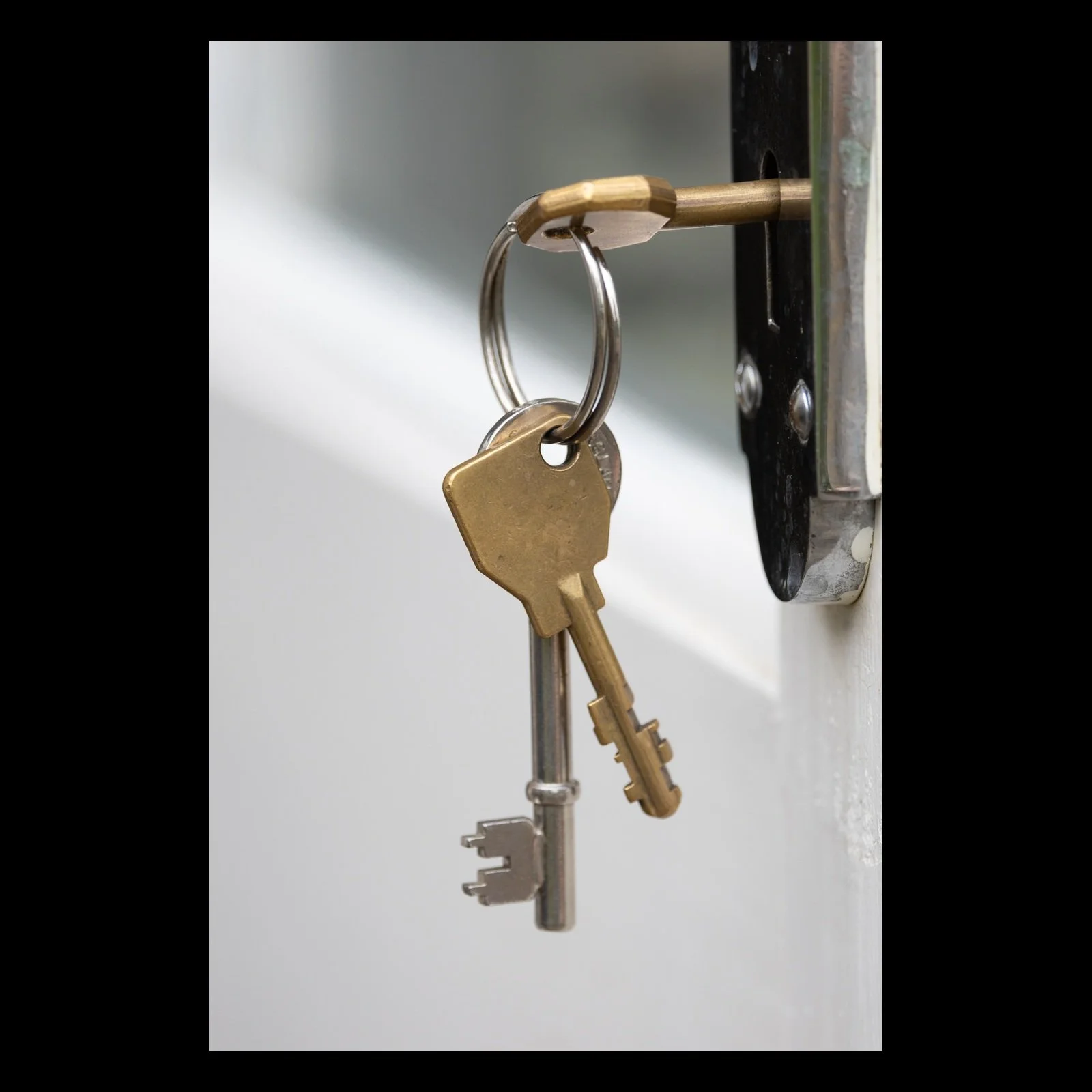 Three Keys vertical still life photograph presented in full against a black background
