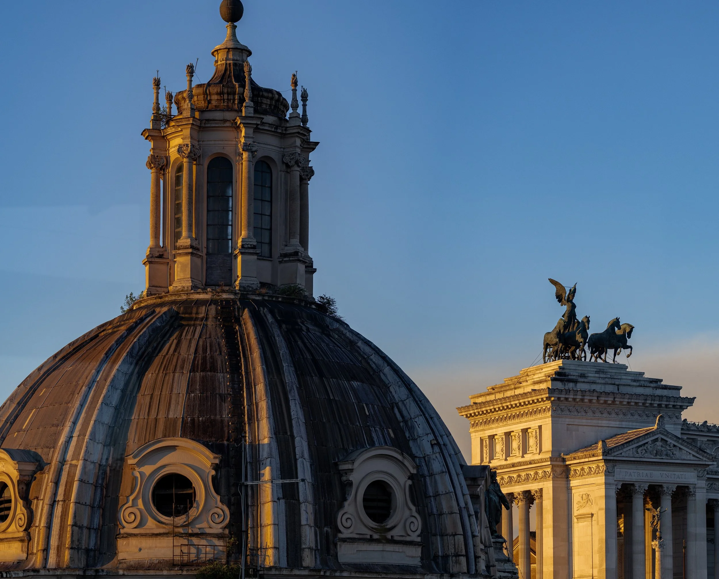 Close detail of the dome lantern, weathered ribs, columns, and distant bronze sculpture