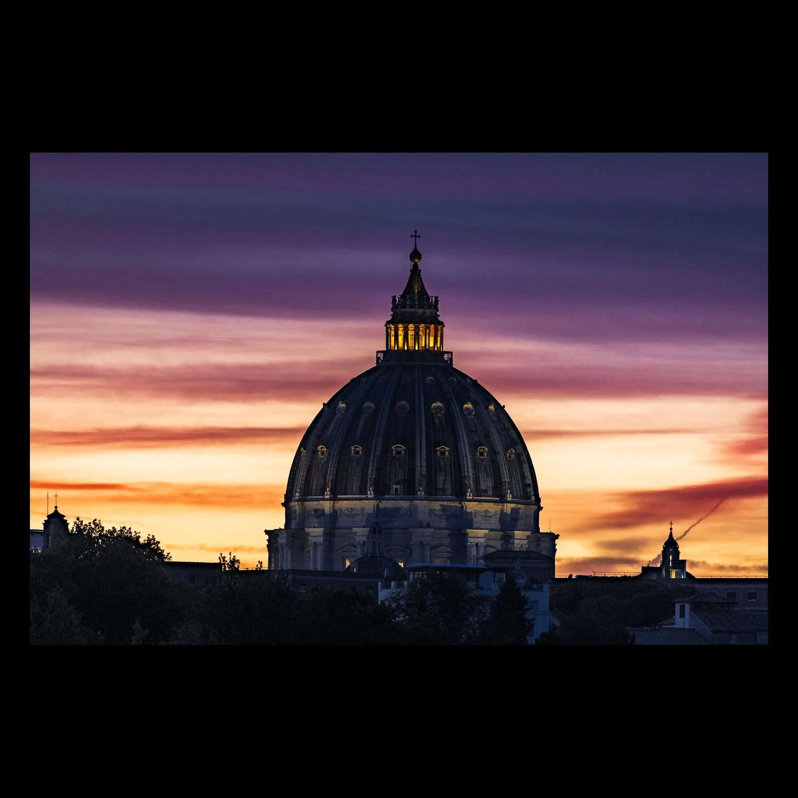 Dusk Benediction photograph of St. Peter's Basilica at sunset, presented in full against a black background
