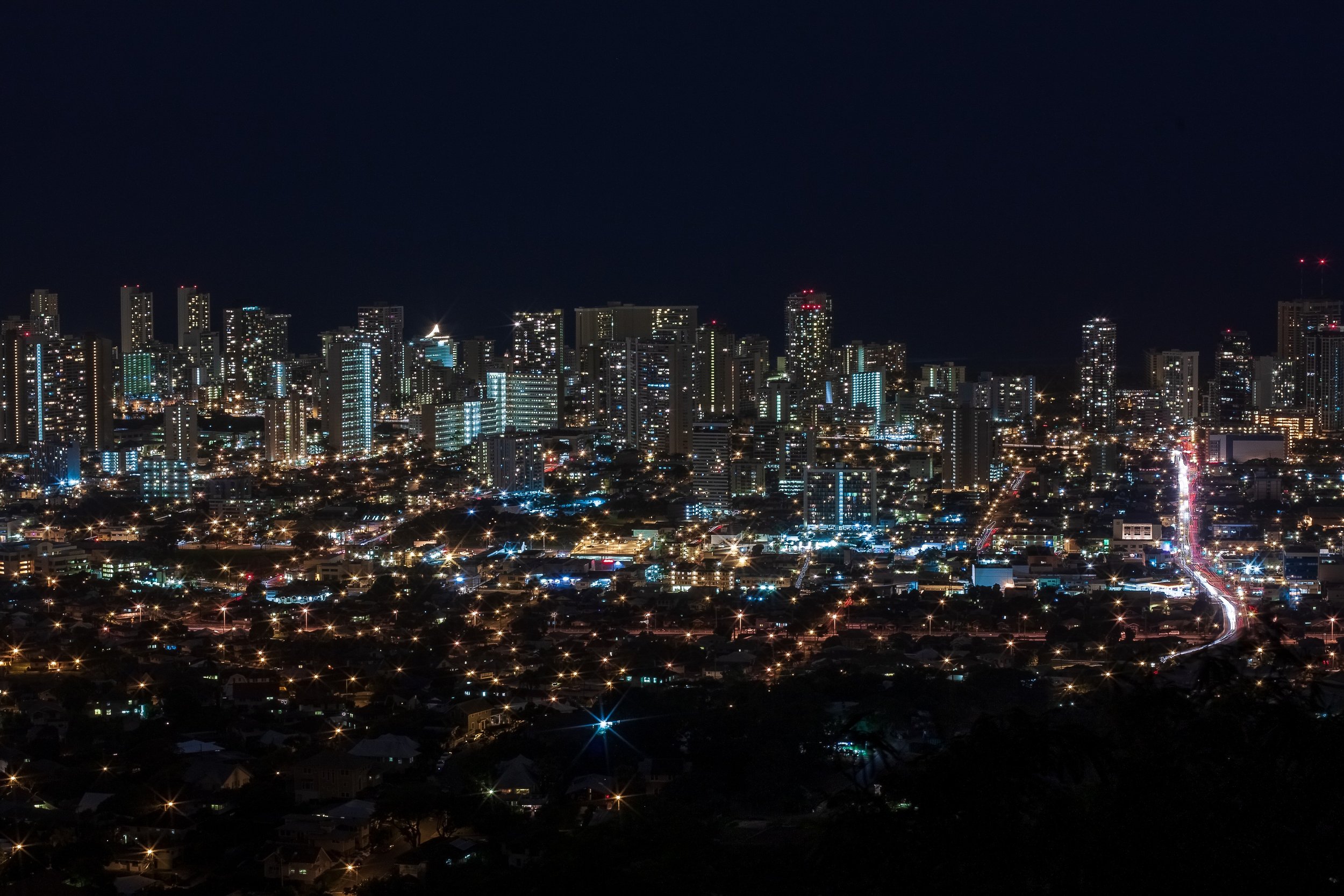 Complete uncropped artwork for Electric Horizon, showing a city skyline glows beneath a nearly black sky, with traffic forming a bright line through the foreground