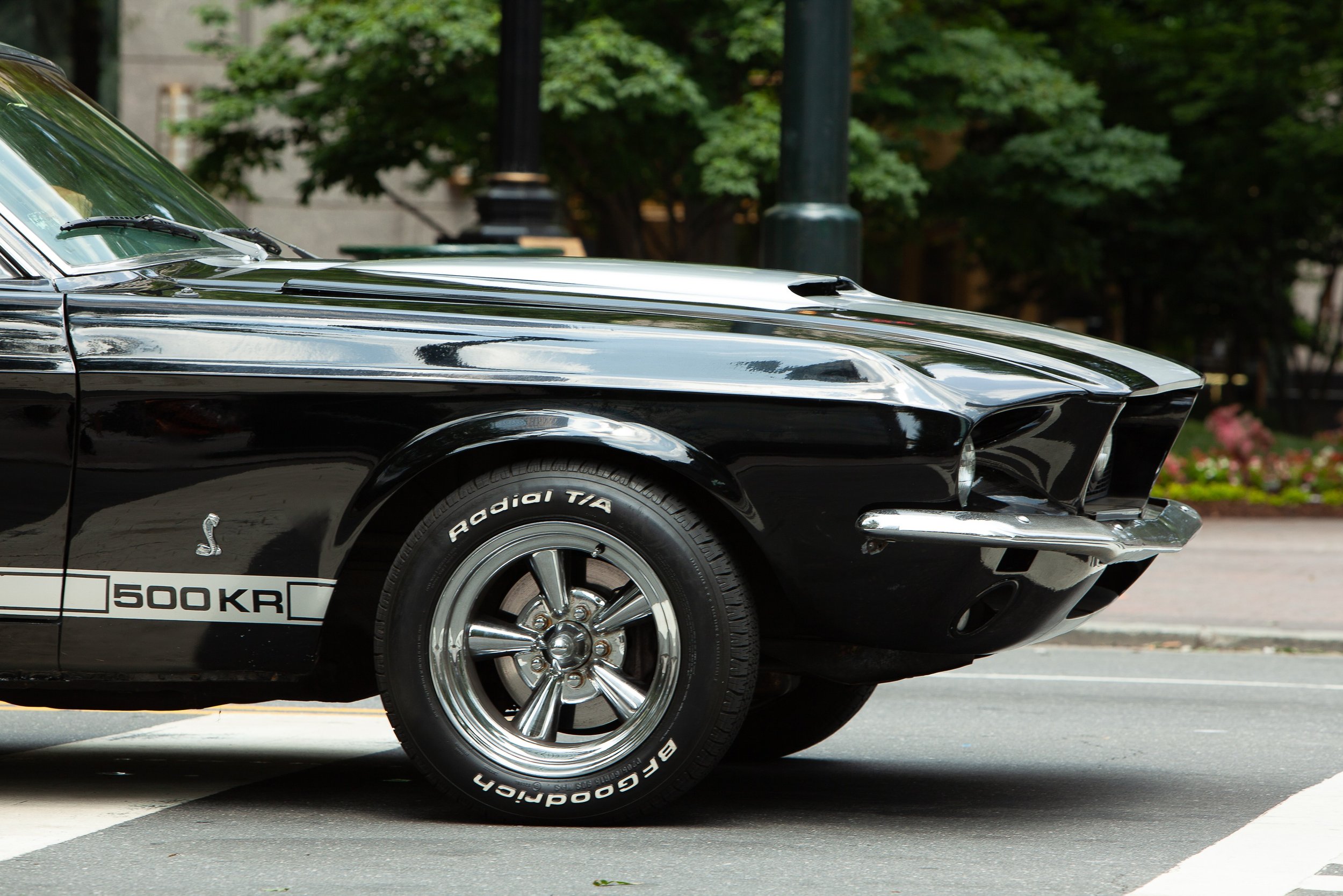 Complete uncropped artwork for Five Hundred Horses, showing the chrome nose and front wheel of a classic muscle car cut across a city street