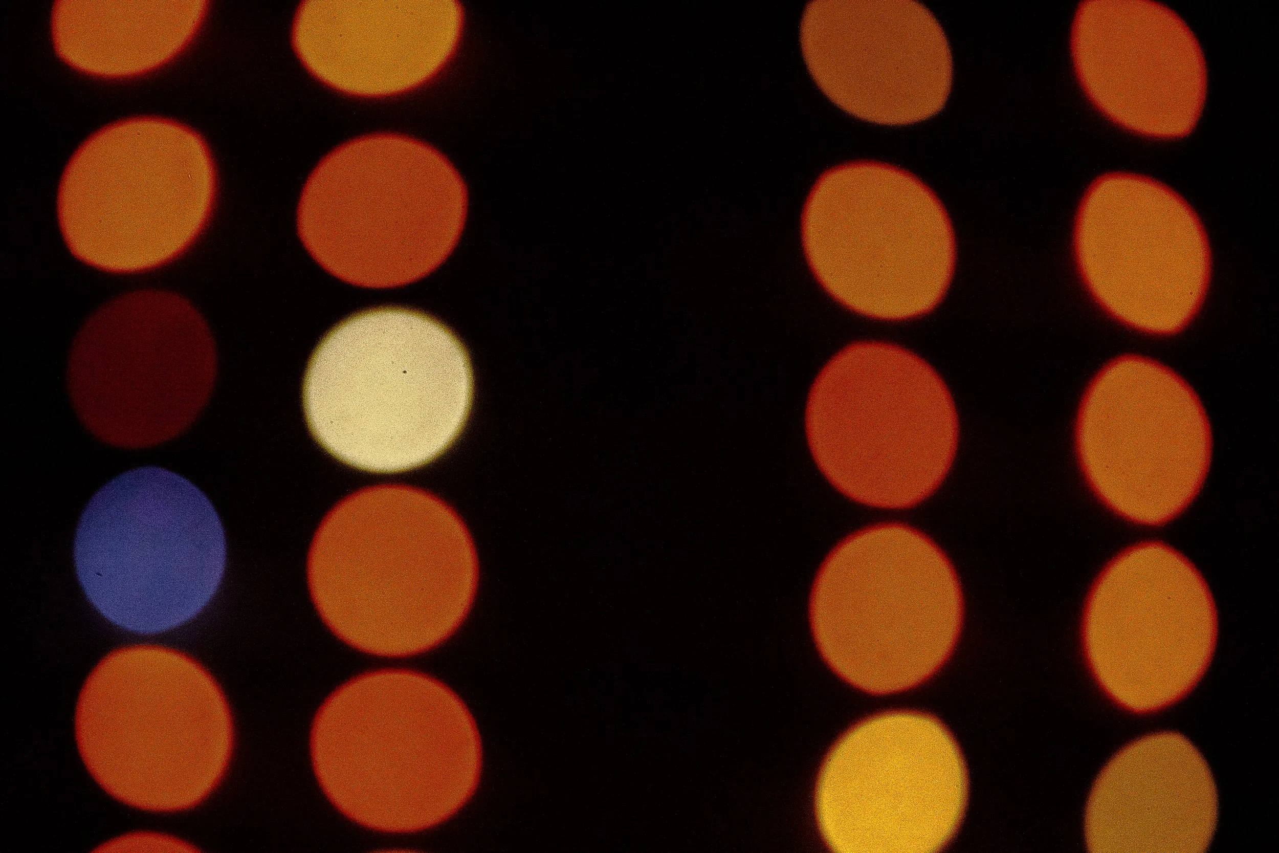 Complete uncropped artwork for Signals at Night, showing rows of warm circular lights float against black with a few cool colors interrupting the pattern