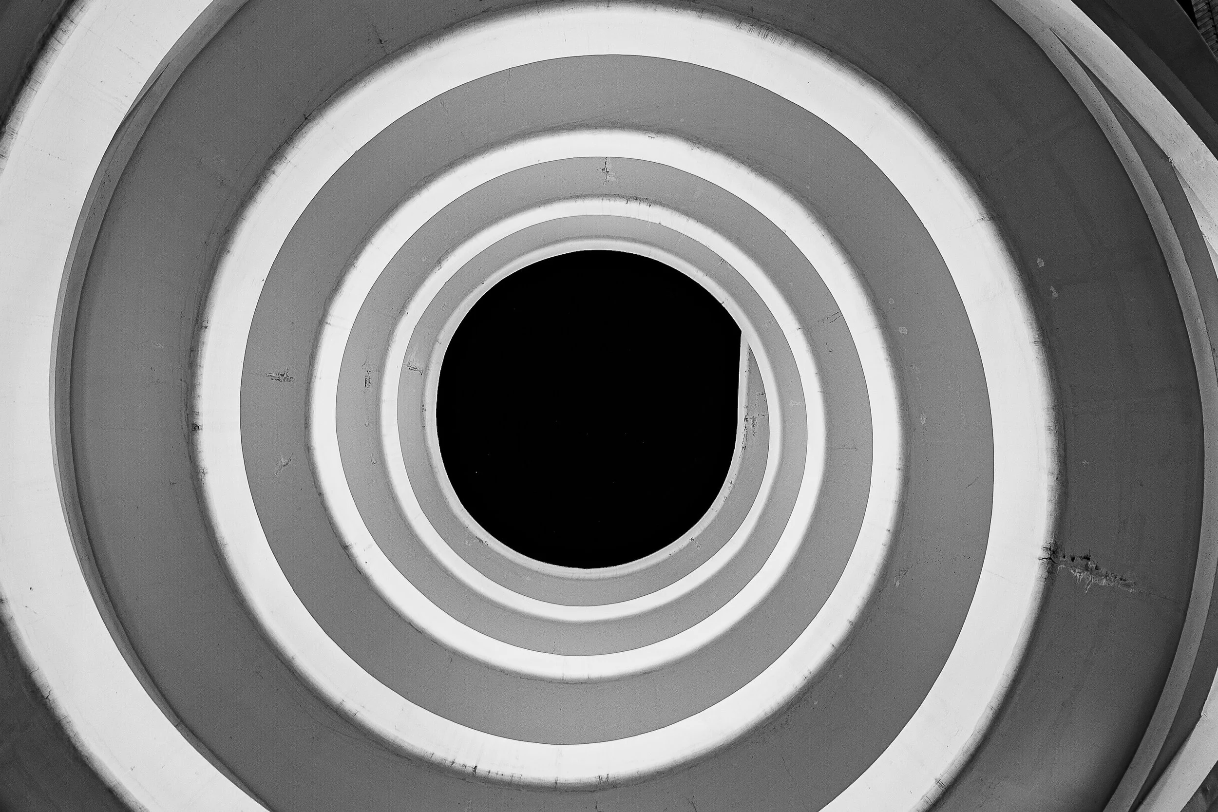Detail crop from Circular Reasoning, emphasizing railings and seams break the circles just enough to reveal the building behind the abstraction