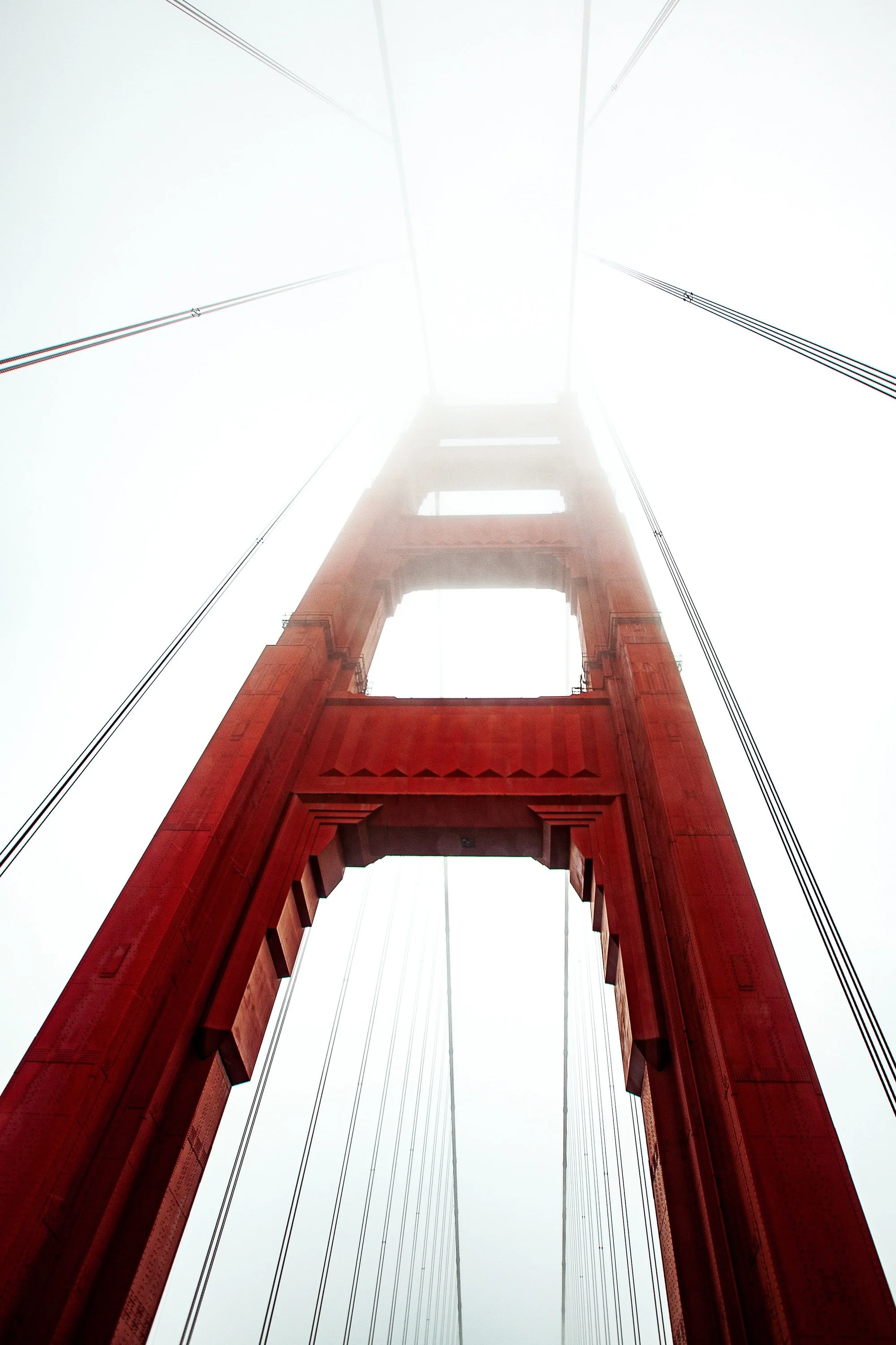 Complete uncropped artwork for Red Span, showing a red suspension-bridge tower rises vertically into a pale fog-filled sky