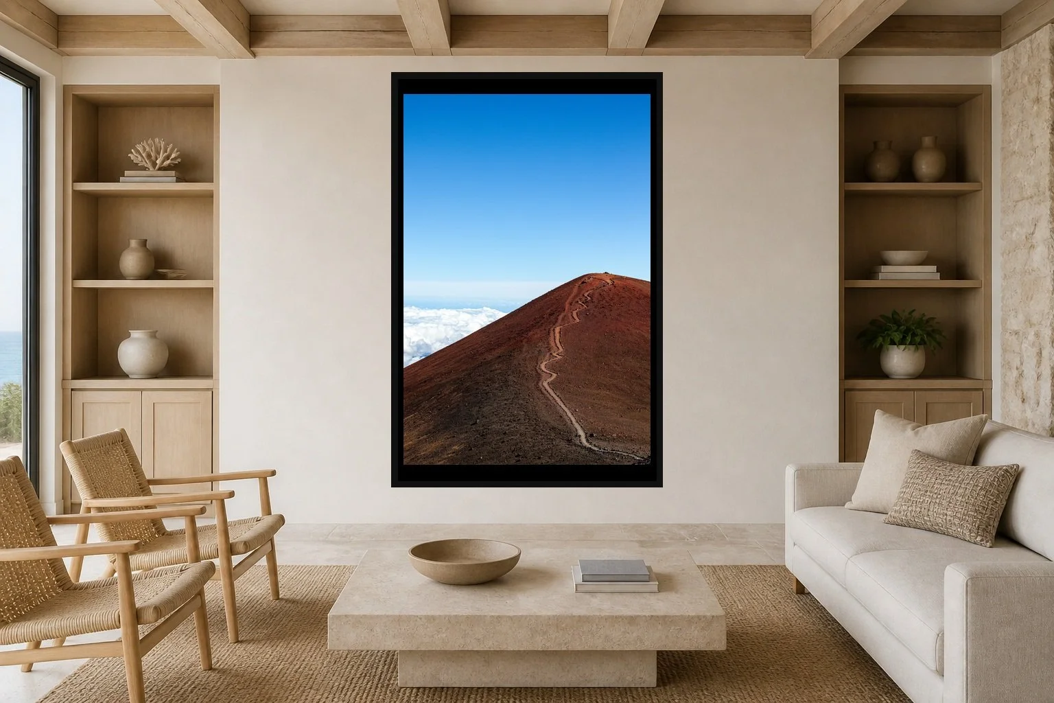 Path Above the Clouds displayed in a black frame within a restrained coastal residence with pale stone, white oak, woven seating, and a clear central wall
