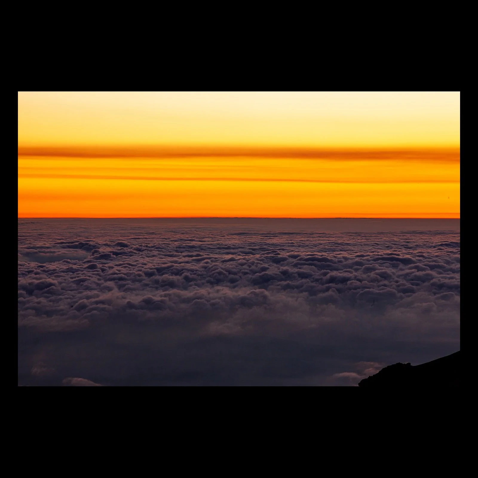 Full-frame black presentation thumbnail of Above the Weather, showing a glowing orange horizon floats above a dense blanket of clouds seen from high elevation