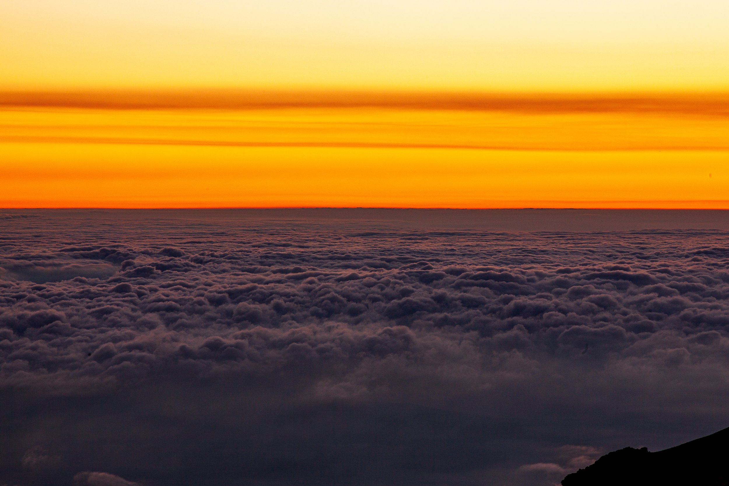 Complete uncropped artwork for Above the Weather, showing a glowing orange horizon floats above a dense blanket of clouds seen from high elevation