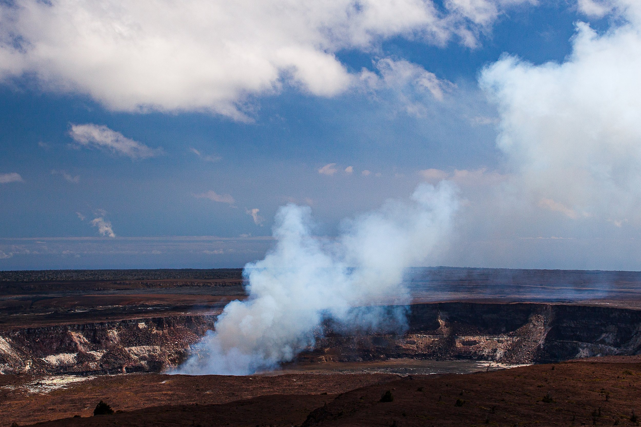 Detail crop from Earth Breathing, emphasizing crater edges and distant ground textures provide scale around the shifting vapor