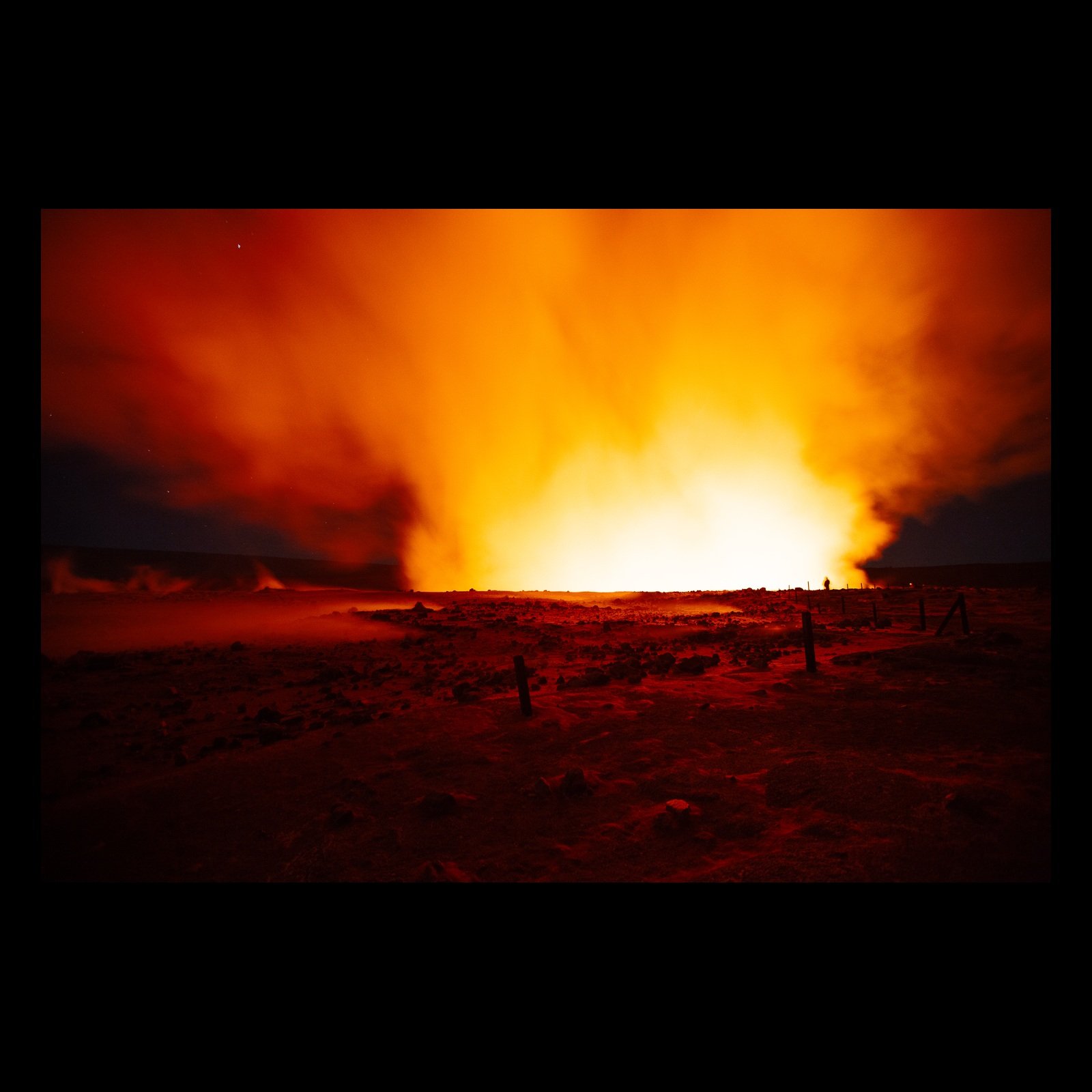 Full-frame black presentation thumbnail of Before the Lava, showing an orange volcanic glow expands across a dark landscape under a smoke-filled night sky