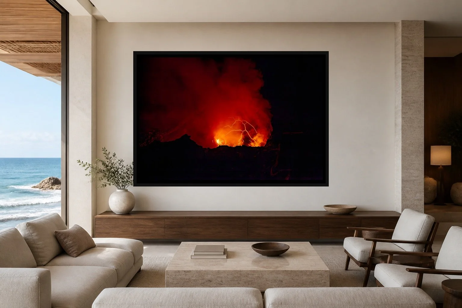 Fire Writes Back displayed in a black frame within a refined oceanfront hotel lounge with pale limestone, walnut, cream linen, and a clear central wall