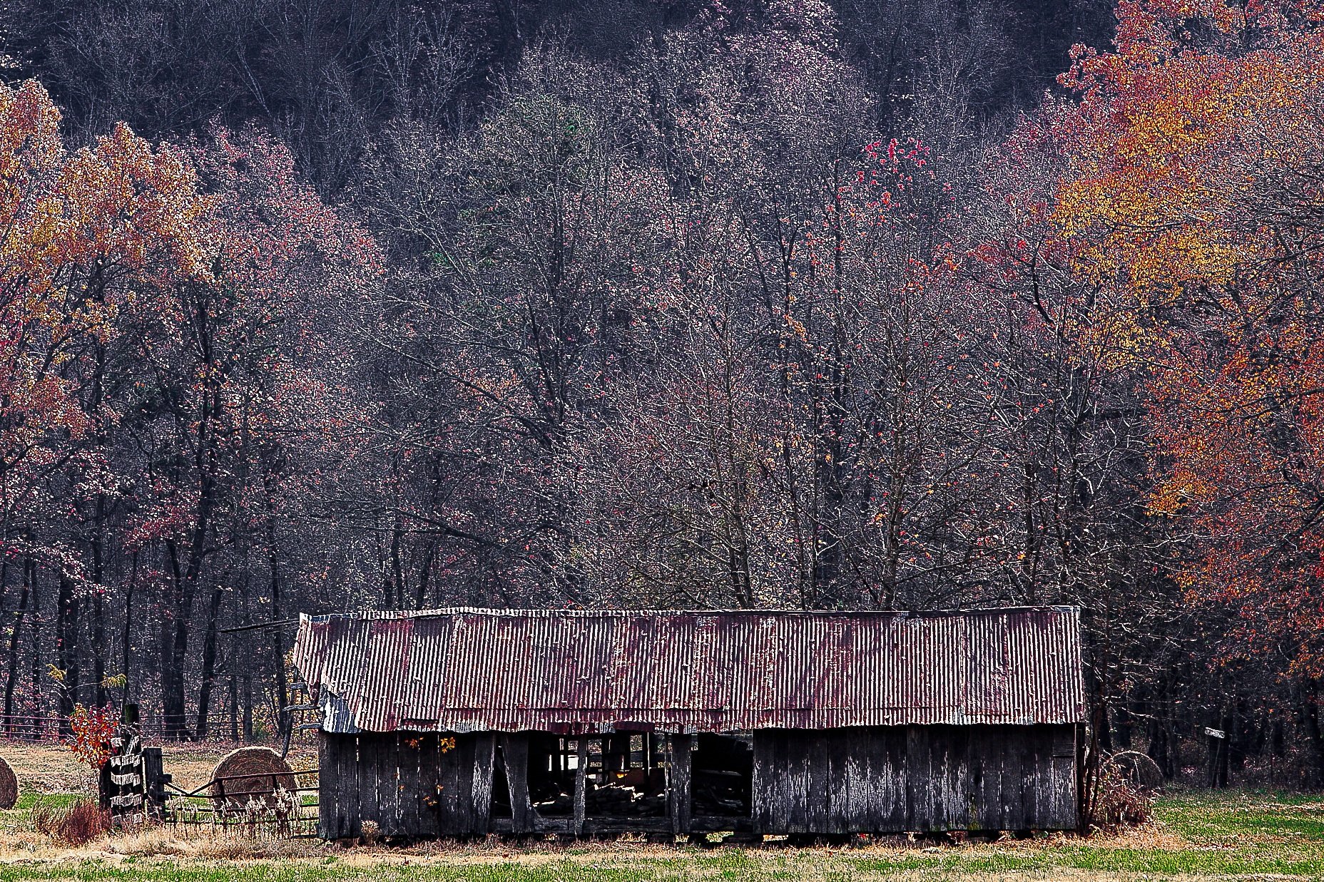 Detail crop from Autumn Holding, emphasizing roof lines, hay bales, and uneven trunks build layers across the rural scene