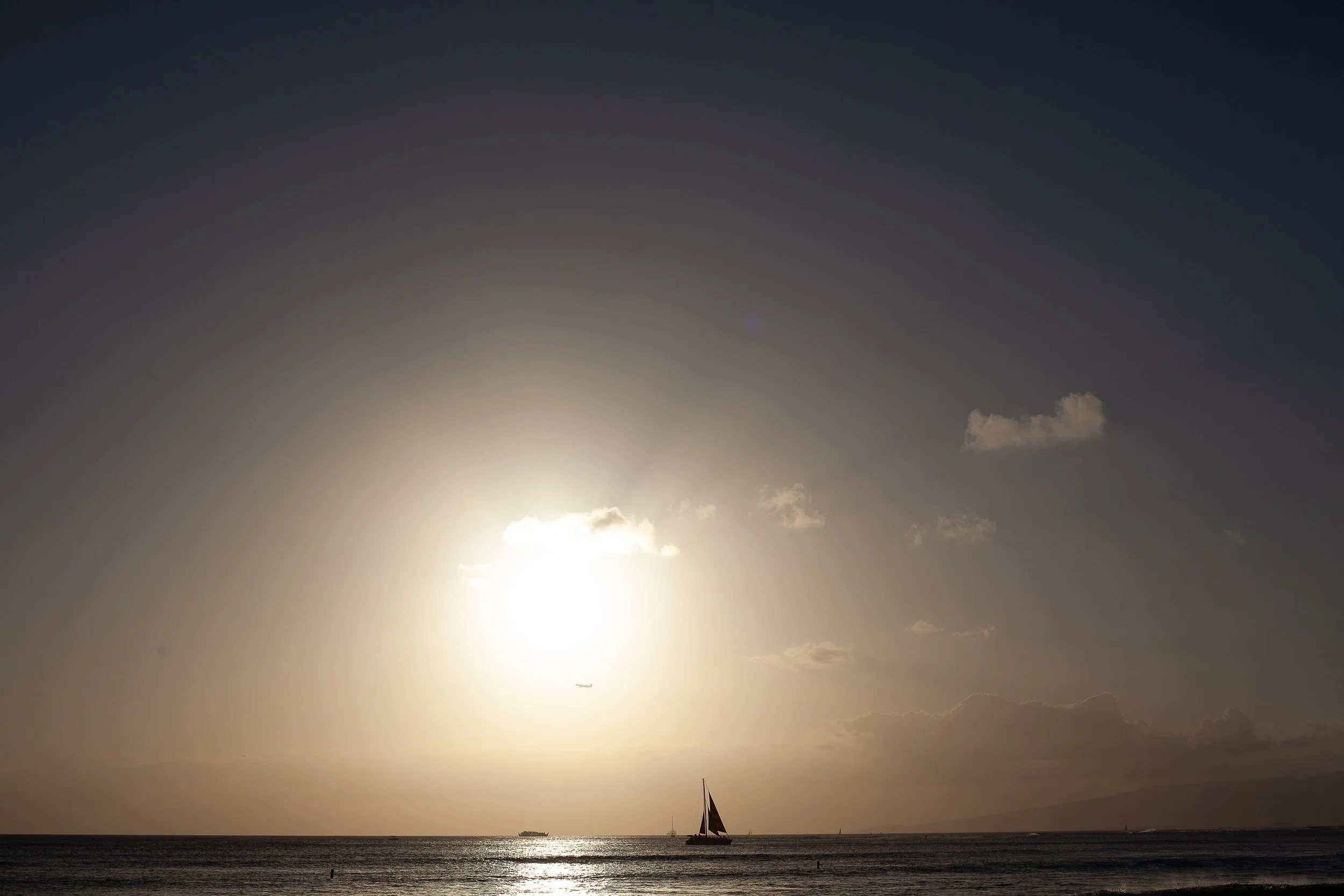 Complete uncropped artwork for Small Sail, Wide Sun, showing a small sailboat crosses beneath a pale sun and a broad hazy sky
