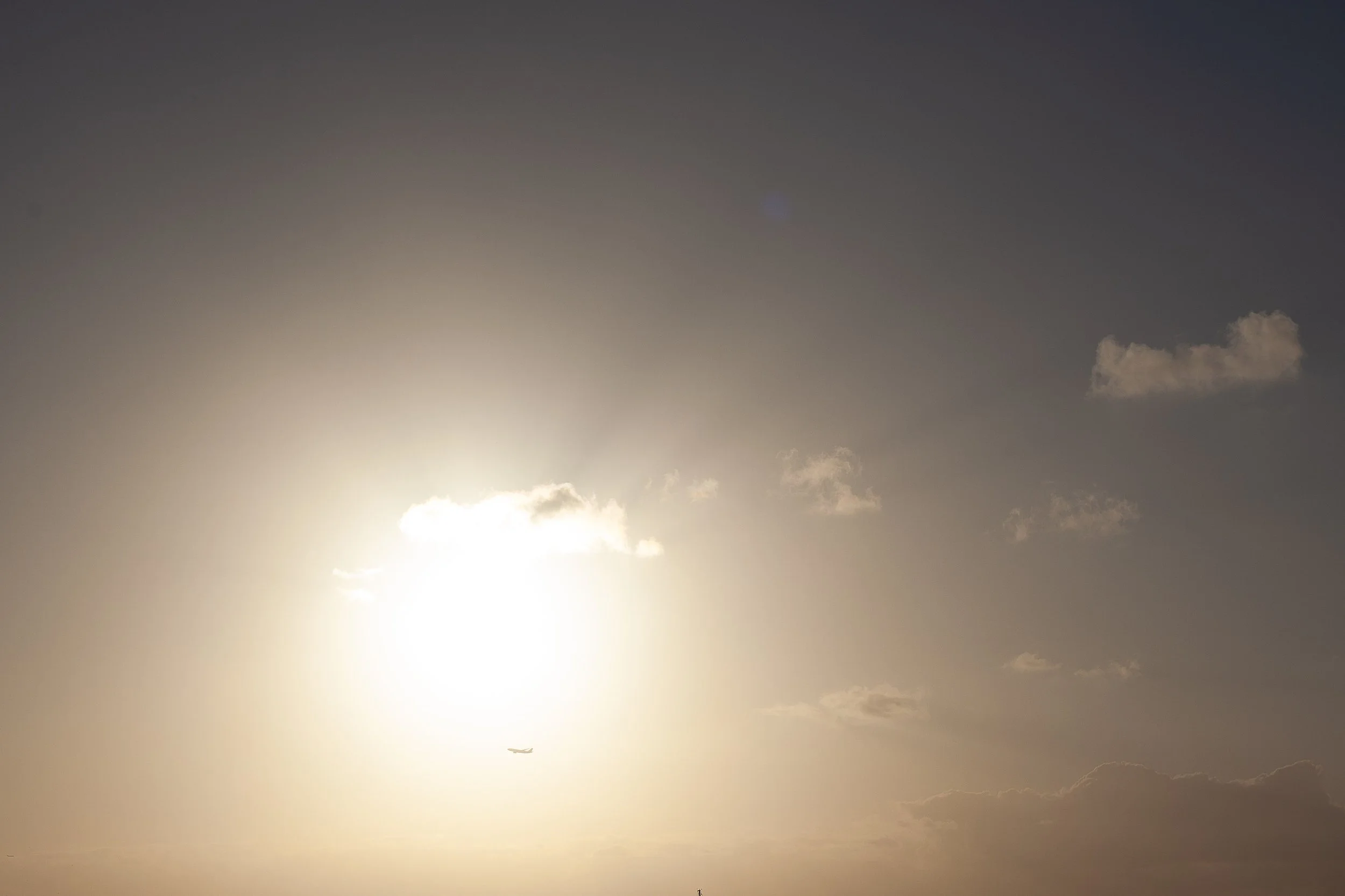 Detail crop from Small Sail, Wide Sun, emphasizing the thin reflection and distant sail become clearer when the eye moves beyond the bright sun