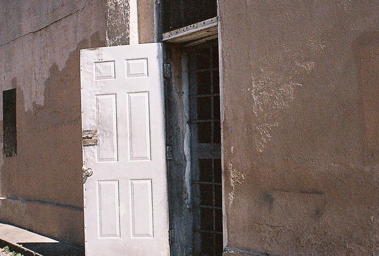 Detail crop from The Open Door, emphasizing cracks, shadows, and uneven paint make the wall as important as the doorway