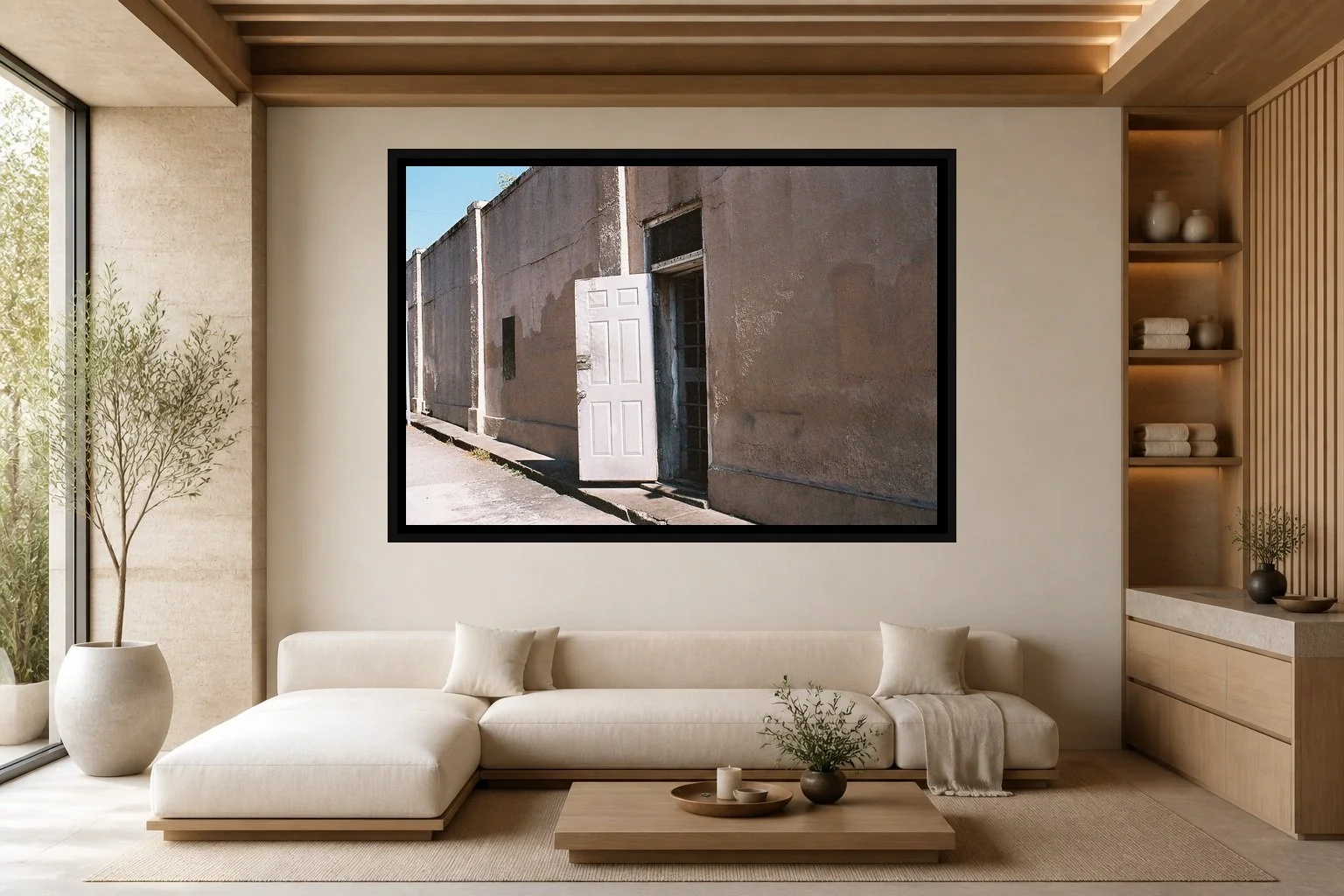 The Open Door displayed in a black frame within a luxury spa lounge with limestone, light ash wood, low cream seating, and a clear central wall