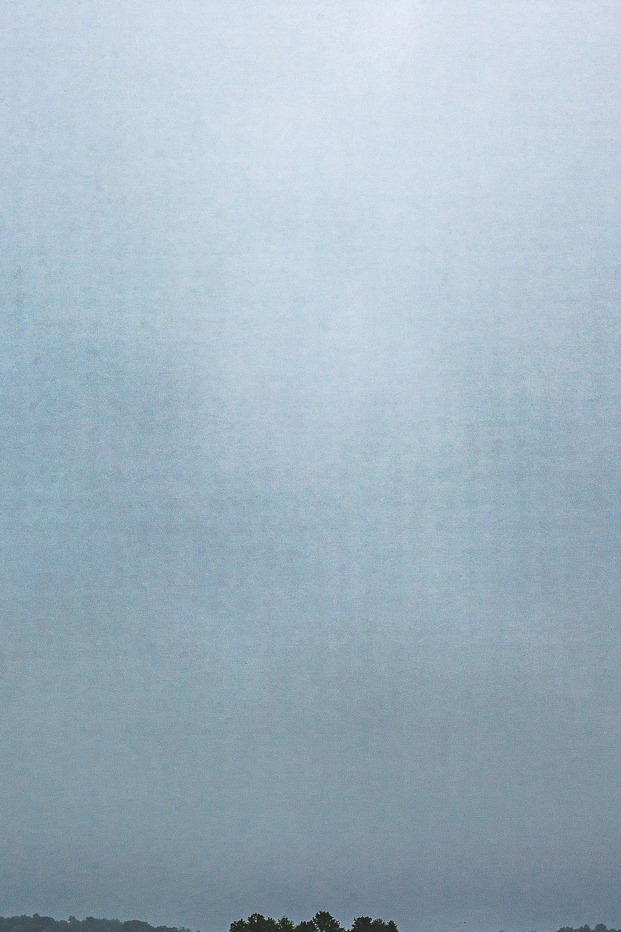 Detail crop from Rain Between Shores, emphasizing subtle tonal changes reveal the shower's width and the island beneath it