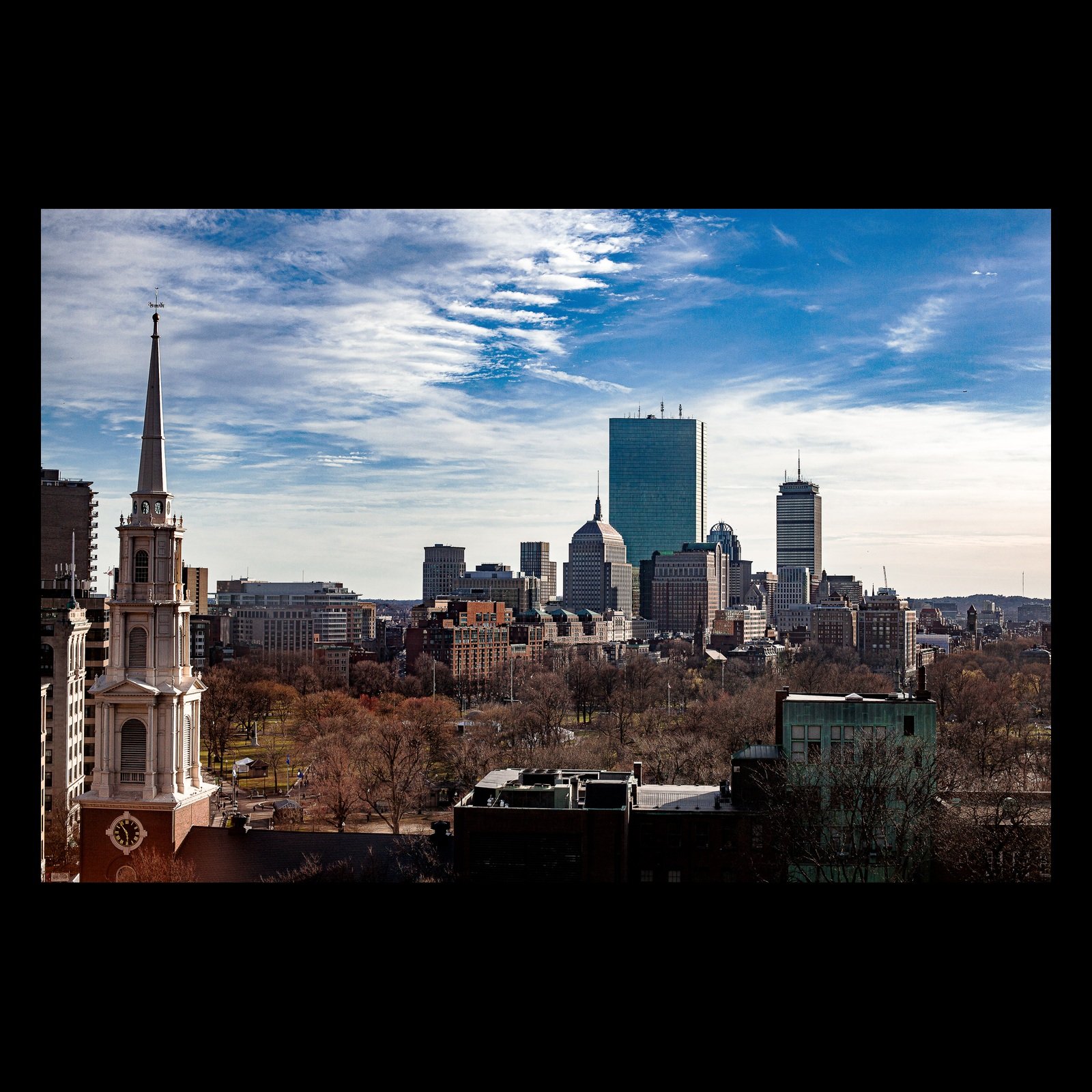 Full-frame black presentation thumbnail of Spires and Glass, showing historic church spires and modern glass towers share a layered urban skyline