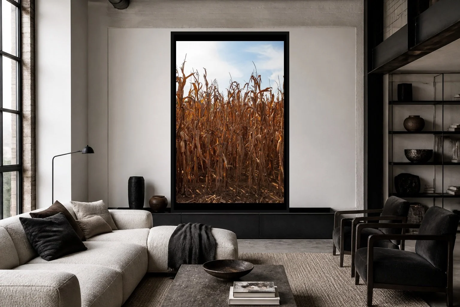 Dry Season displayed in a black frame within a modern collector's loft with white plaster, blackened steel, textured fabrics, and a clear central wall