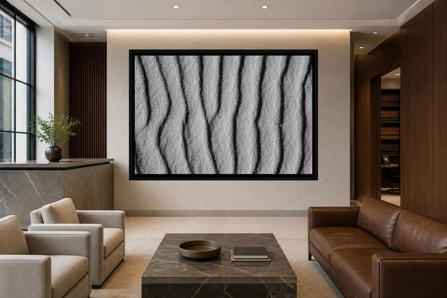 Wind Written displayed in a black frame within an upscale law-office reception area with honed stone, walnut paneling, quiet seating, and a clear central wall