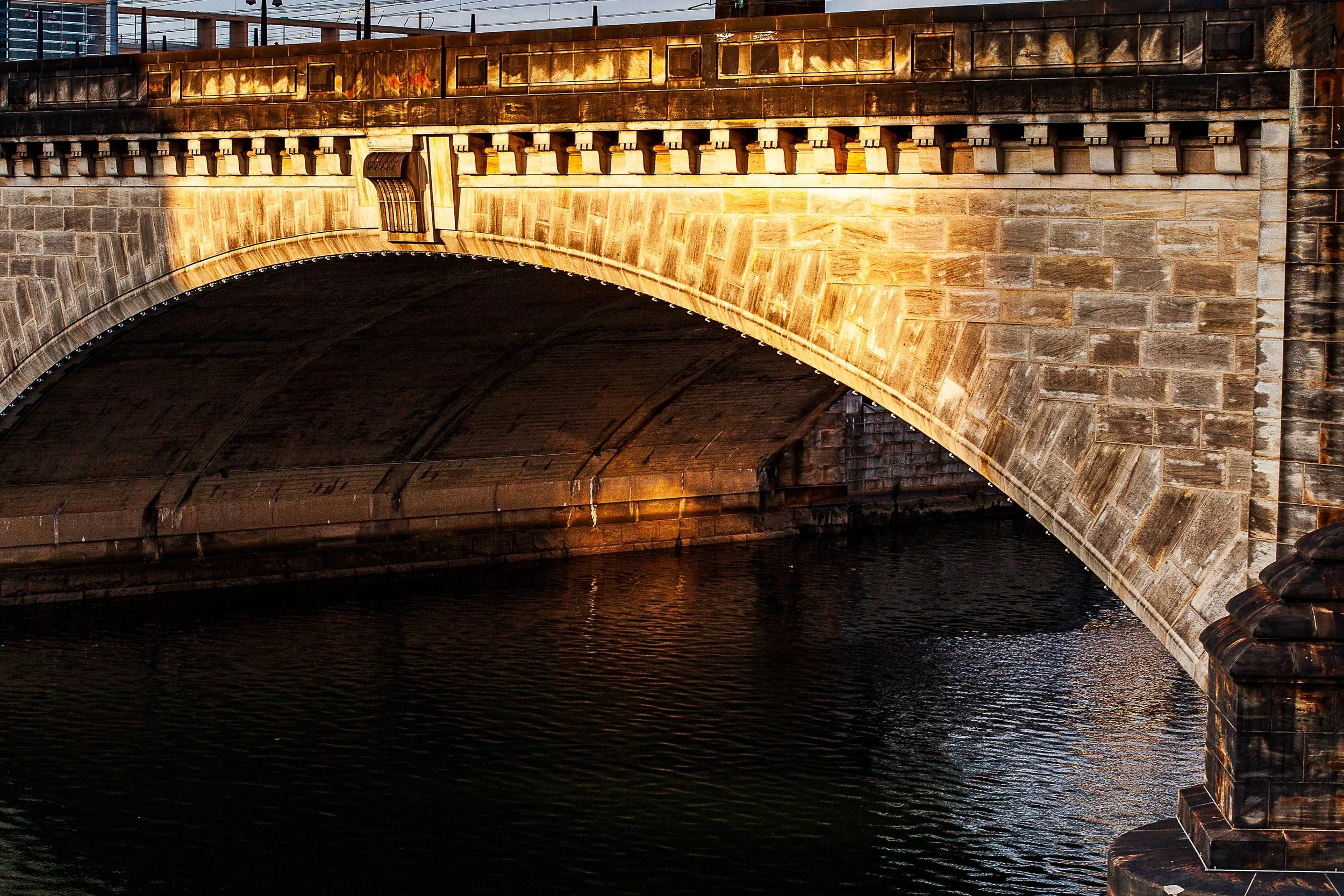Detail crop from Stone Crossing, emphasizing brickwork, rail lines, and broken reflections reveal the bridge's layered construction