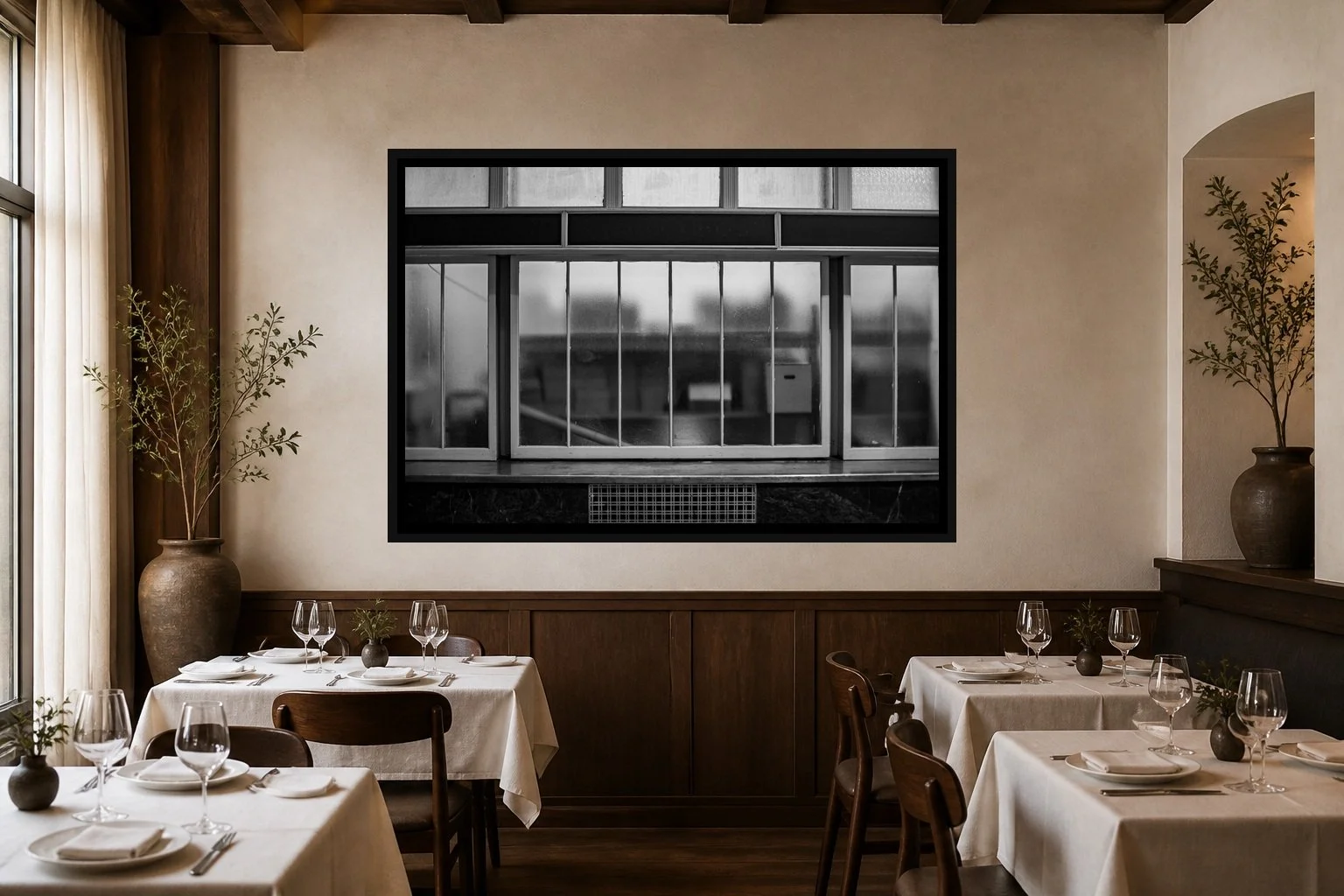 Frosted Interior displayed in a black frame within an intimate fine-dining room with plaster walls, dark wood, linen tables, no guests, and a clear central wall