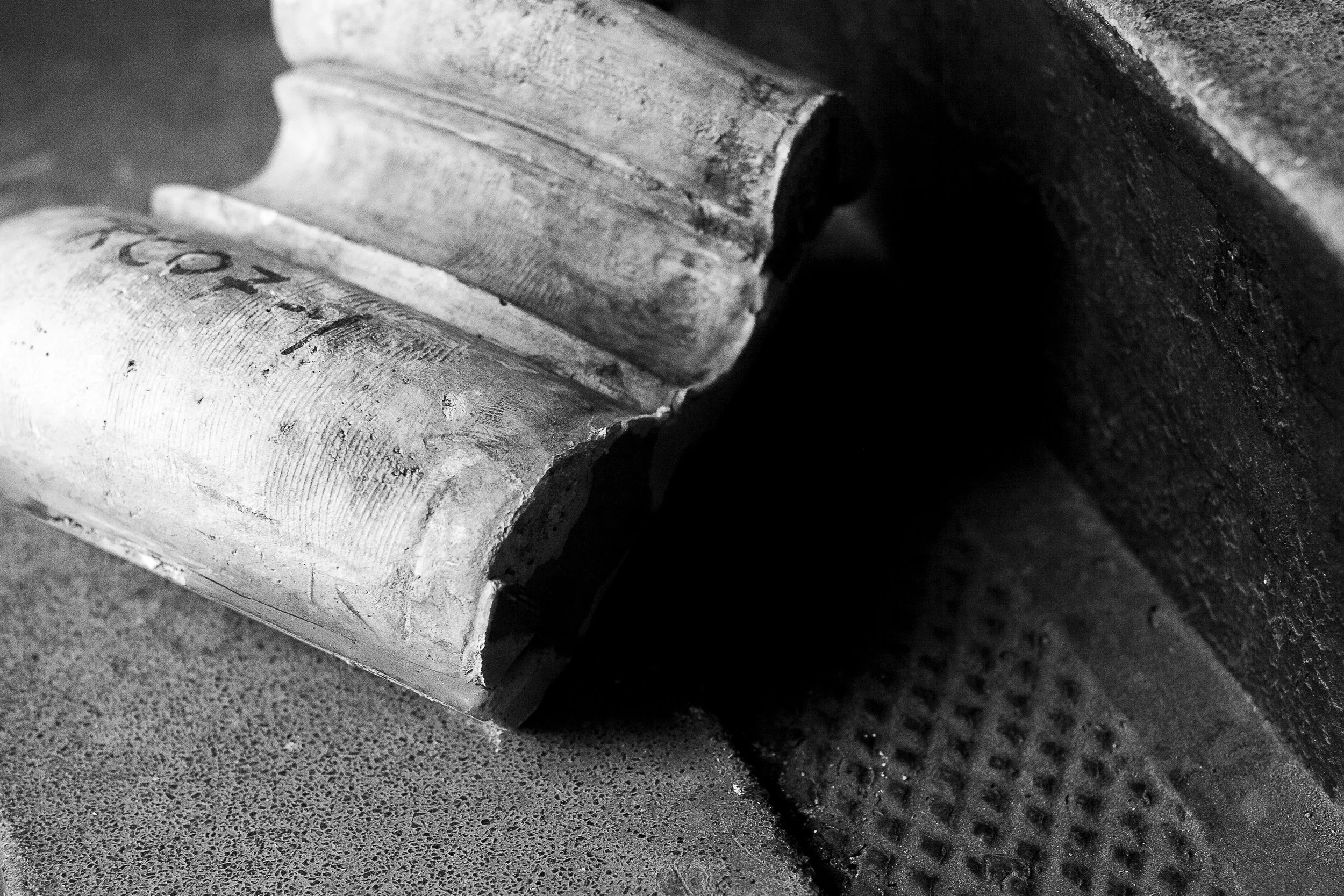 Detail crop from Fallen Fragment, emphasizing chips, dust, and carved curves preserve traces of its former place