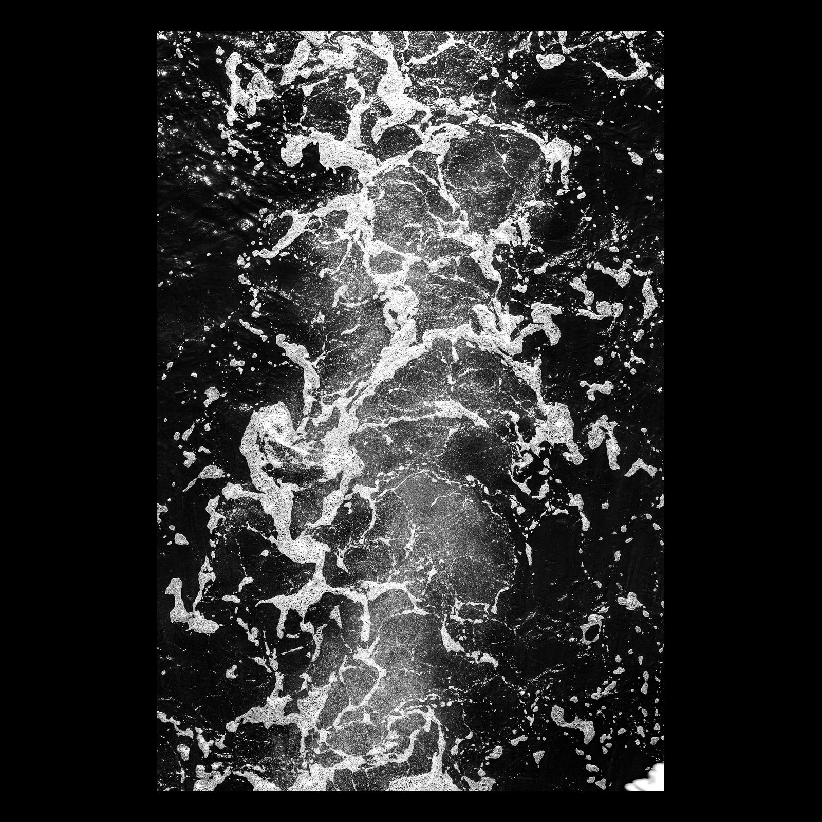 Full-frame black presentation thumbnail of Black Water, showing white sea foam twists through nearly black water in a vertical overhead study