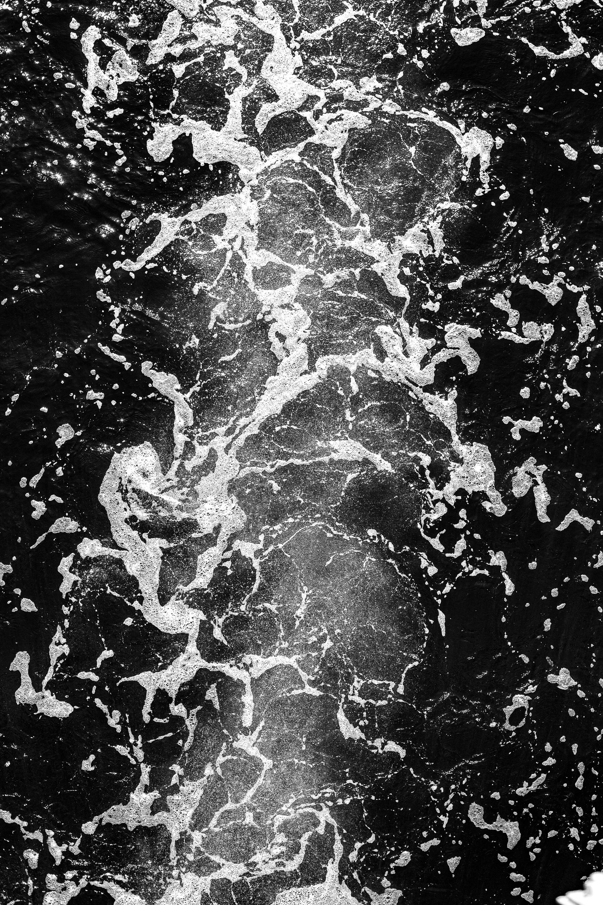Complete uncropped artwork for Black Water, showing white sea foam twists through nearly black water in a vertical overhead study
