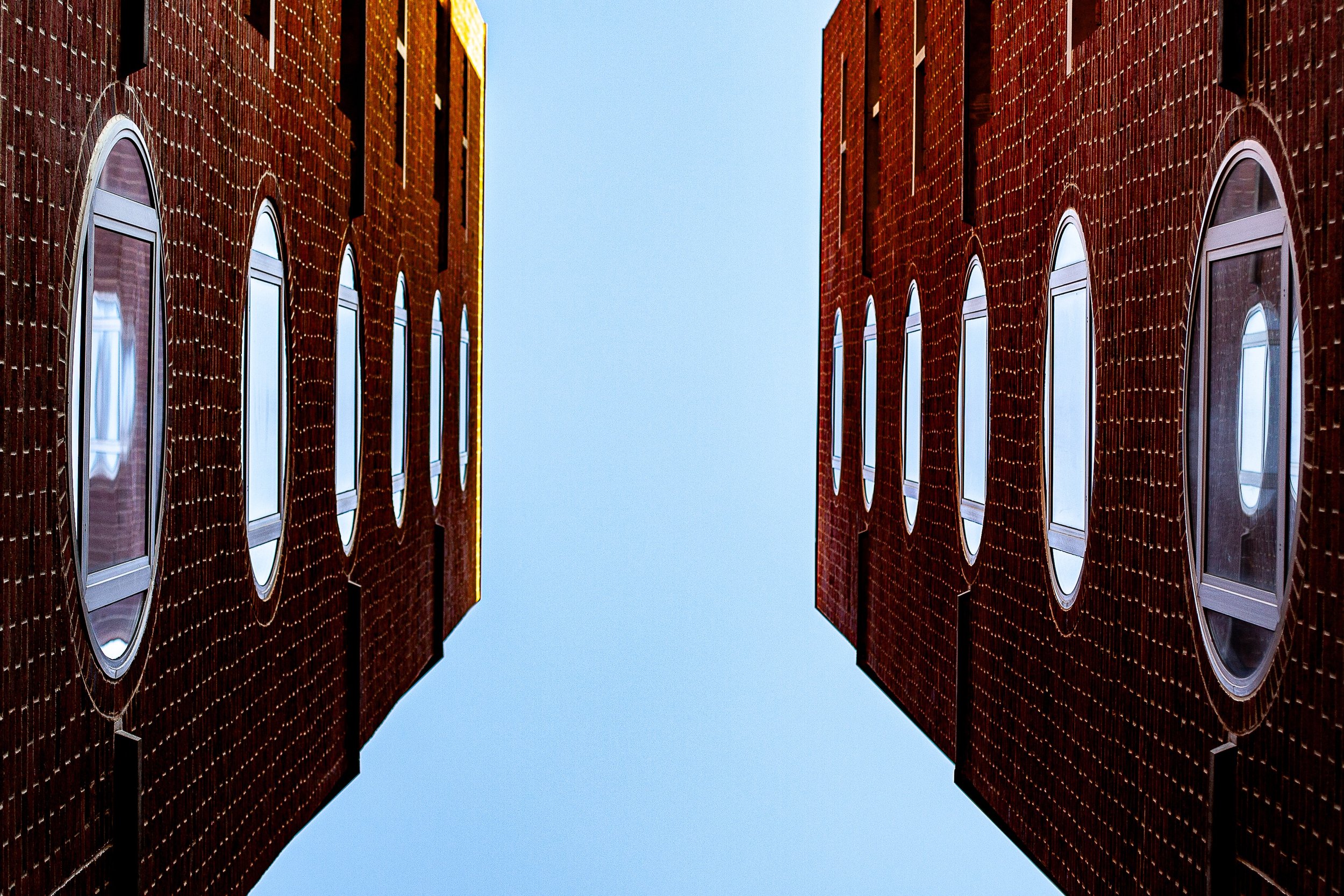 Detail crop from Sky Courtyard, emphasizing slight differences in brick and window placement keep the symmetry unsettled