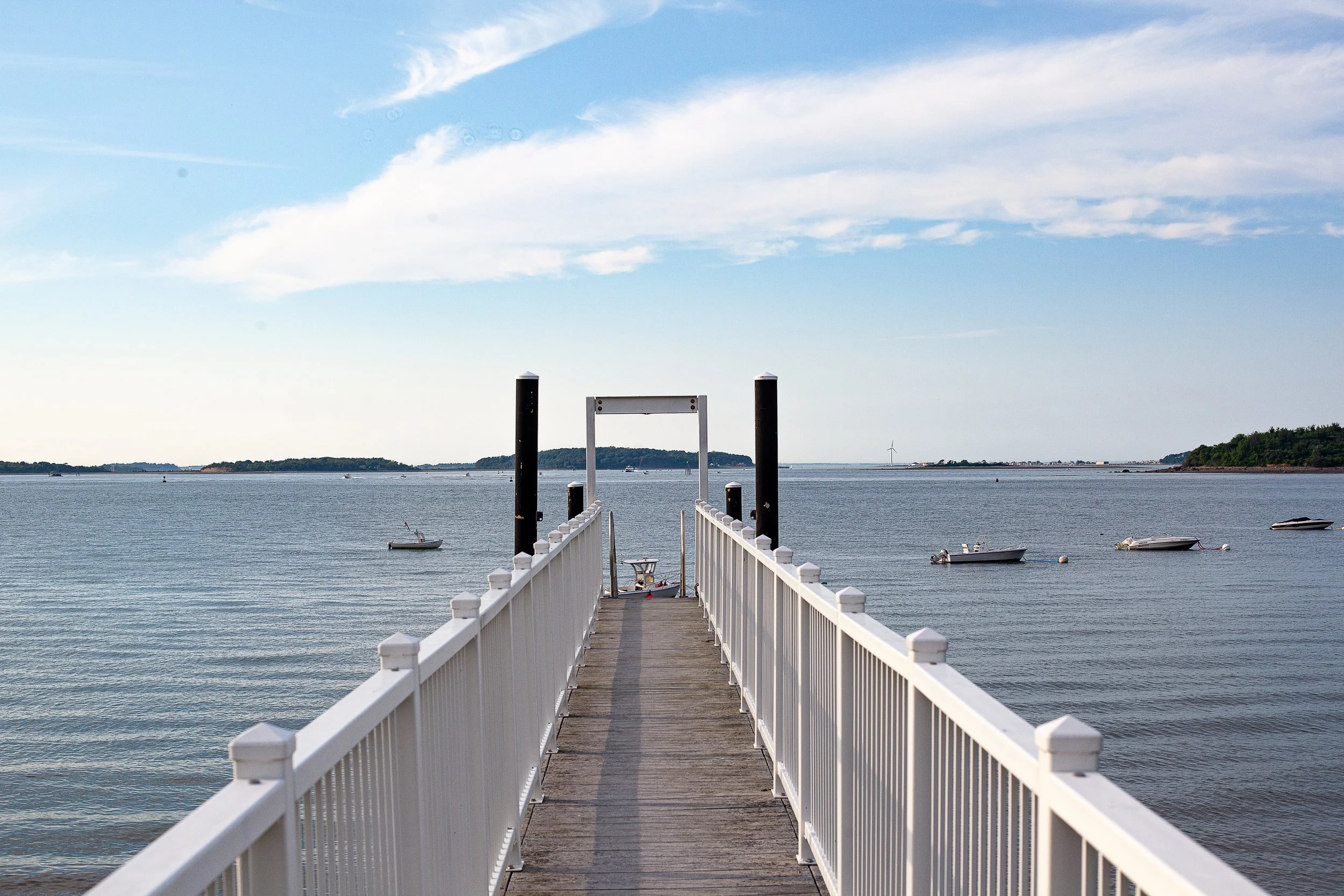 Complete uncropped artwork for Walk to the Water, showing a long white-railed dock leads directly toward calm open water and small anchored boats