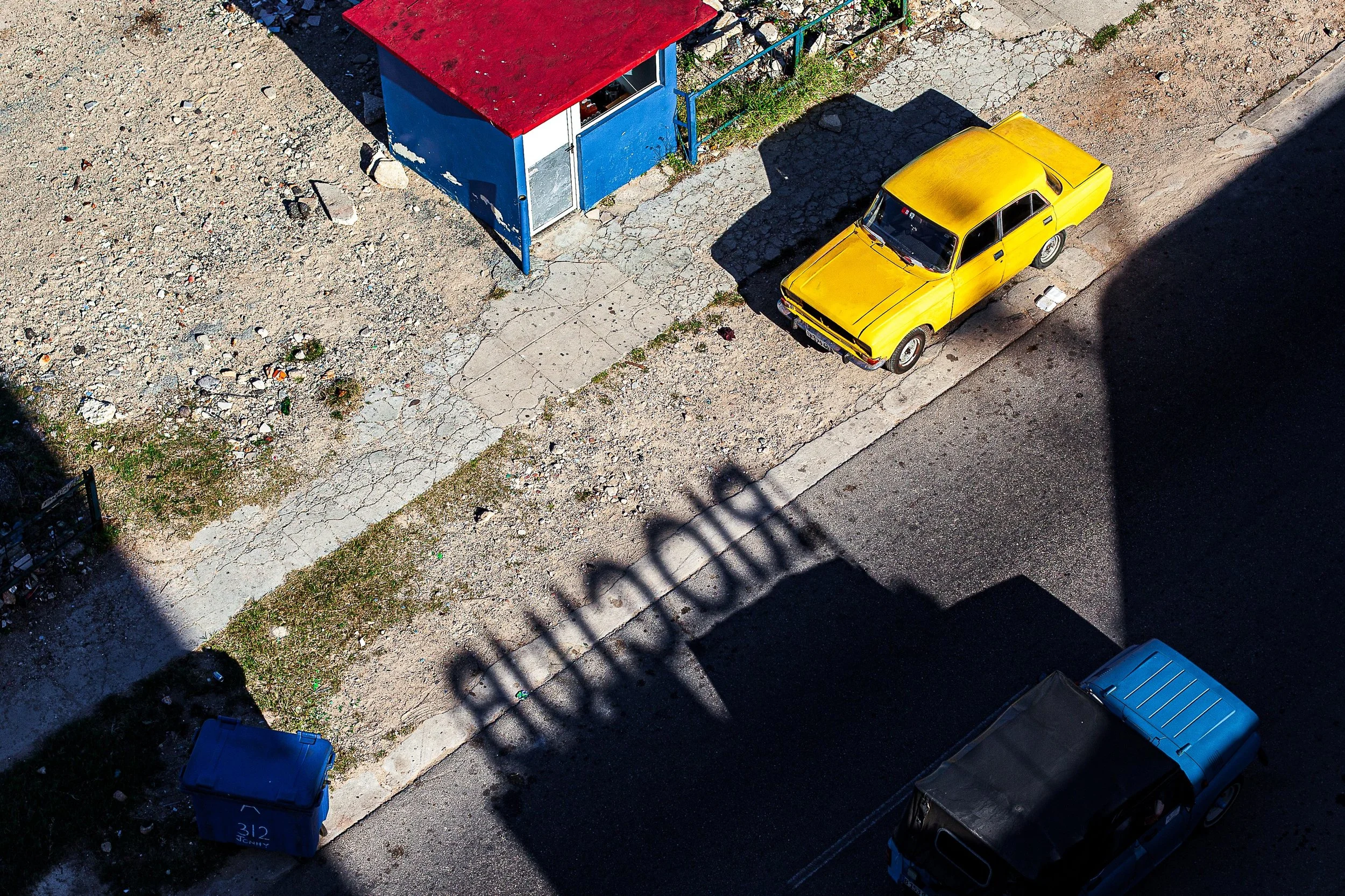 Detail crop from Primary Geometry, emphasizing smaller vehicles and broken pavement complicate the bold arrangement